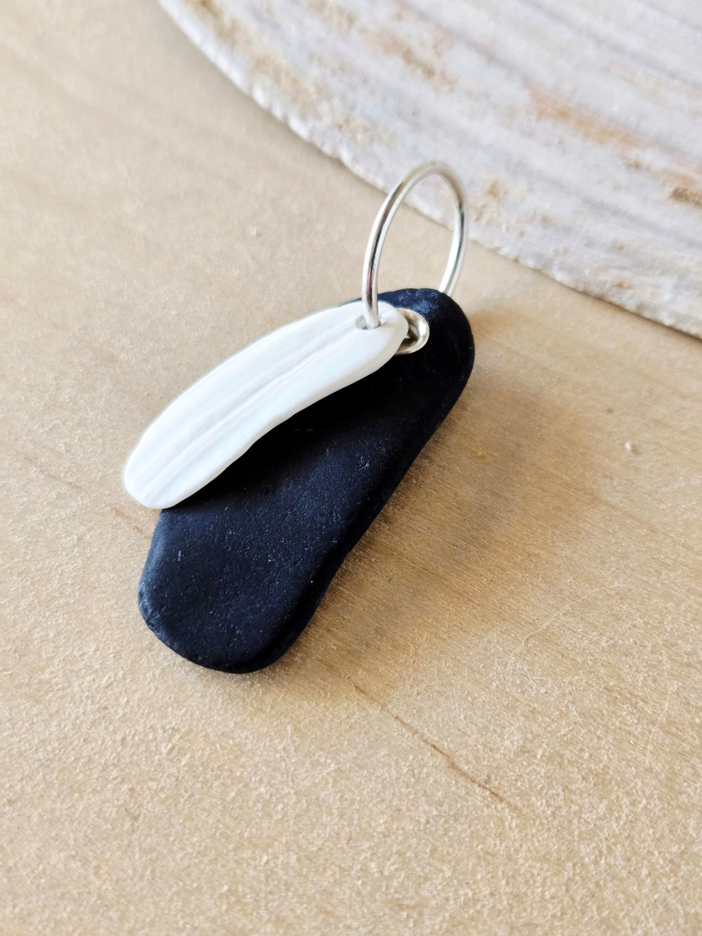 Black Beach Stone & White Shell Charm