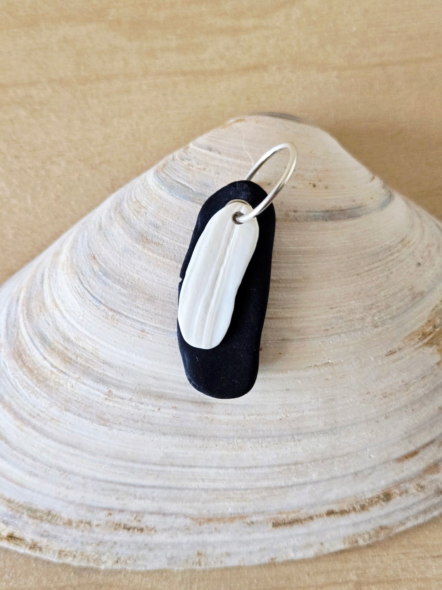 Black Beach Stone & White Shell Charm