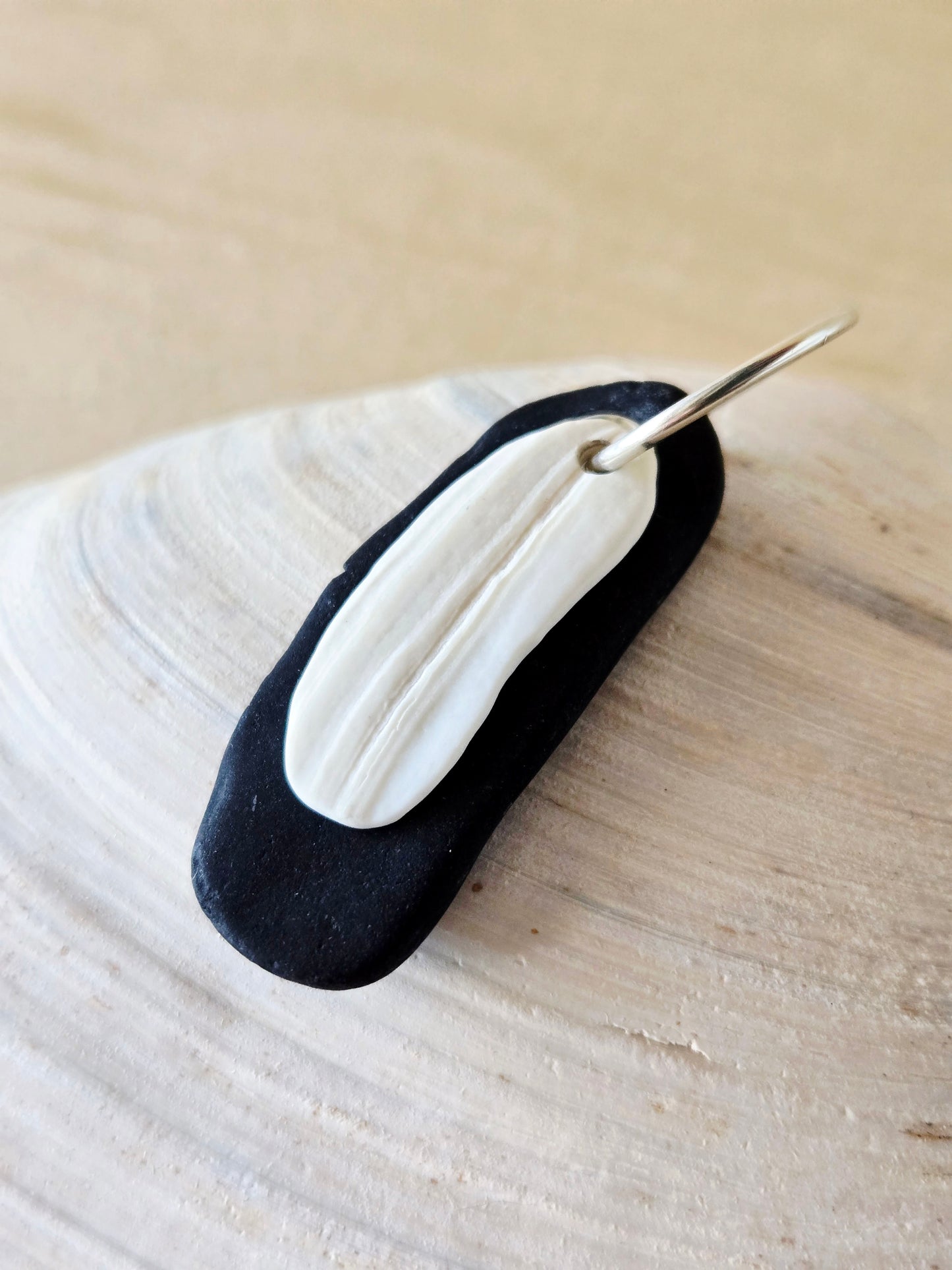 Black Beach Stone & White Shell Charm
