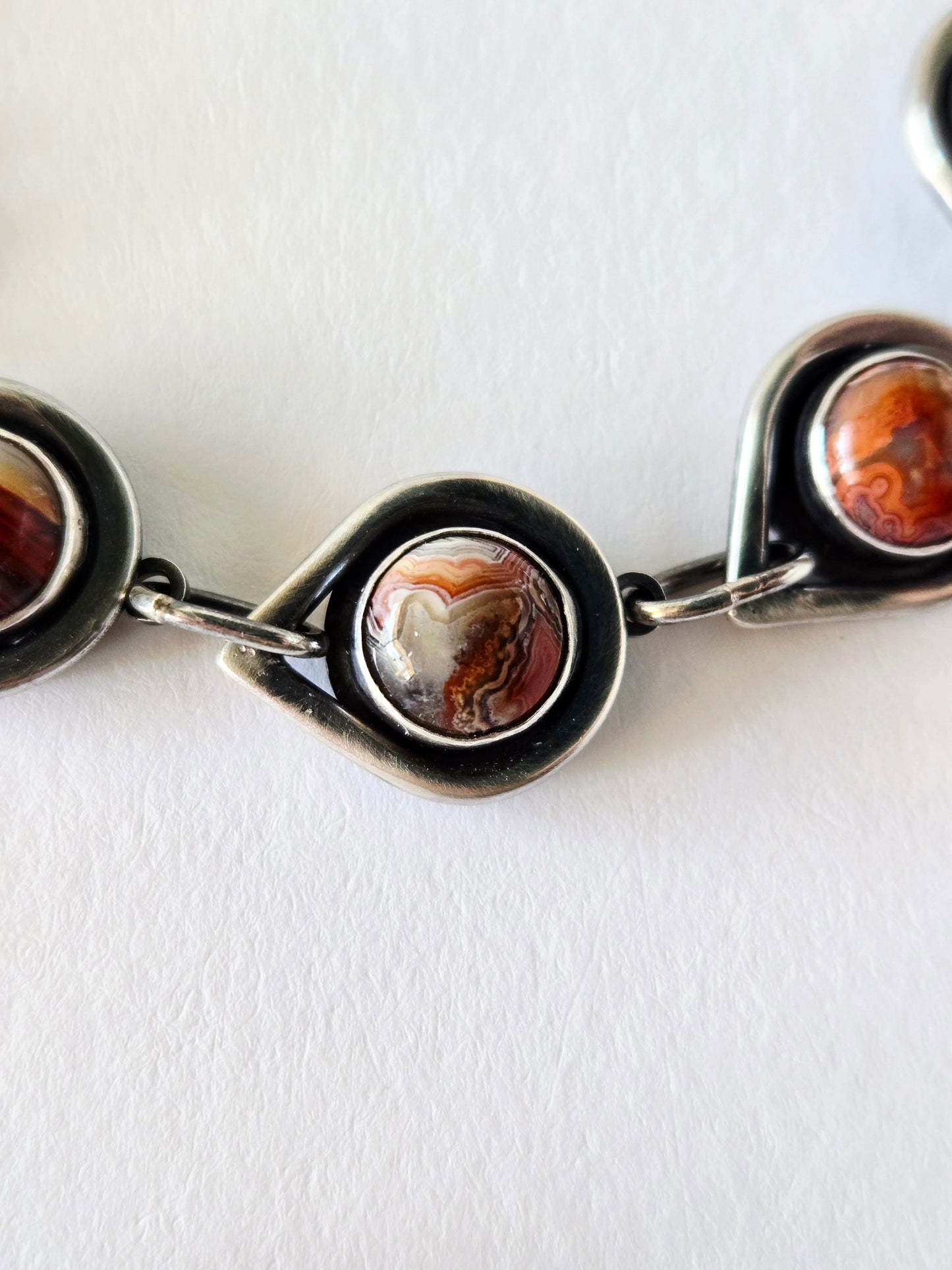 closeup of bracelet detail with colorful agate on a white background