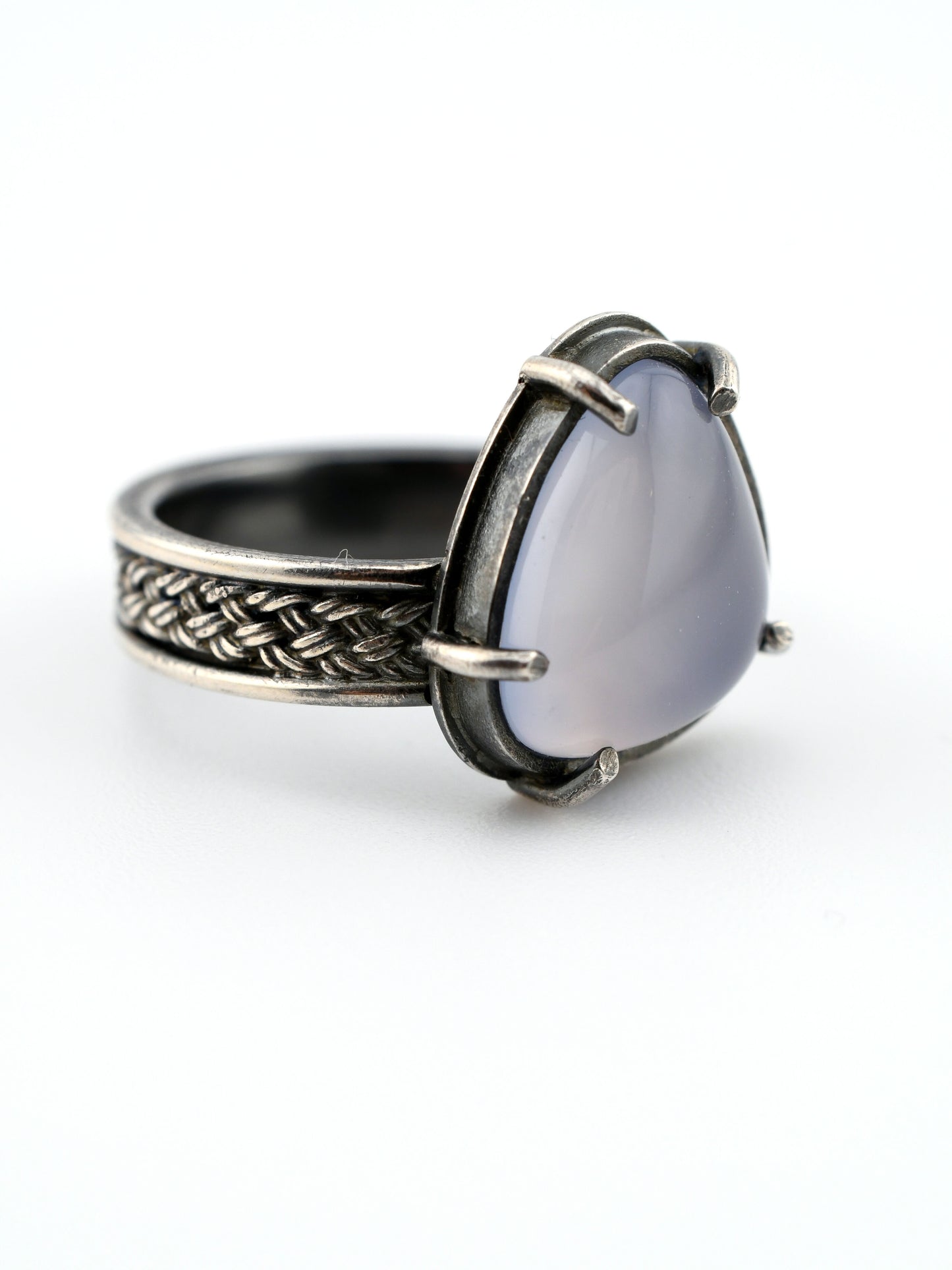 Silver ring with a lavender stone on a white background