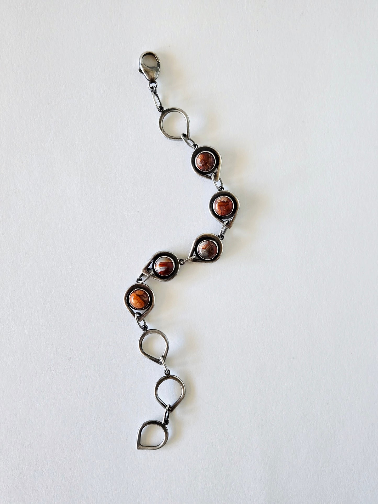 Silver and agate bracelet shown extended on a white background