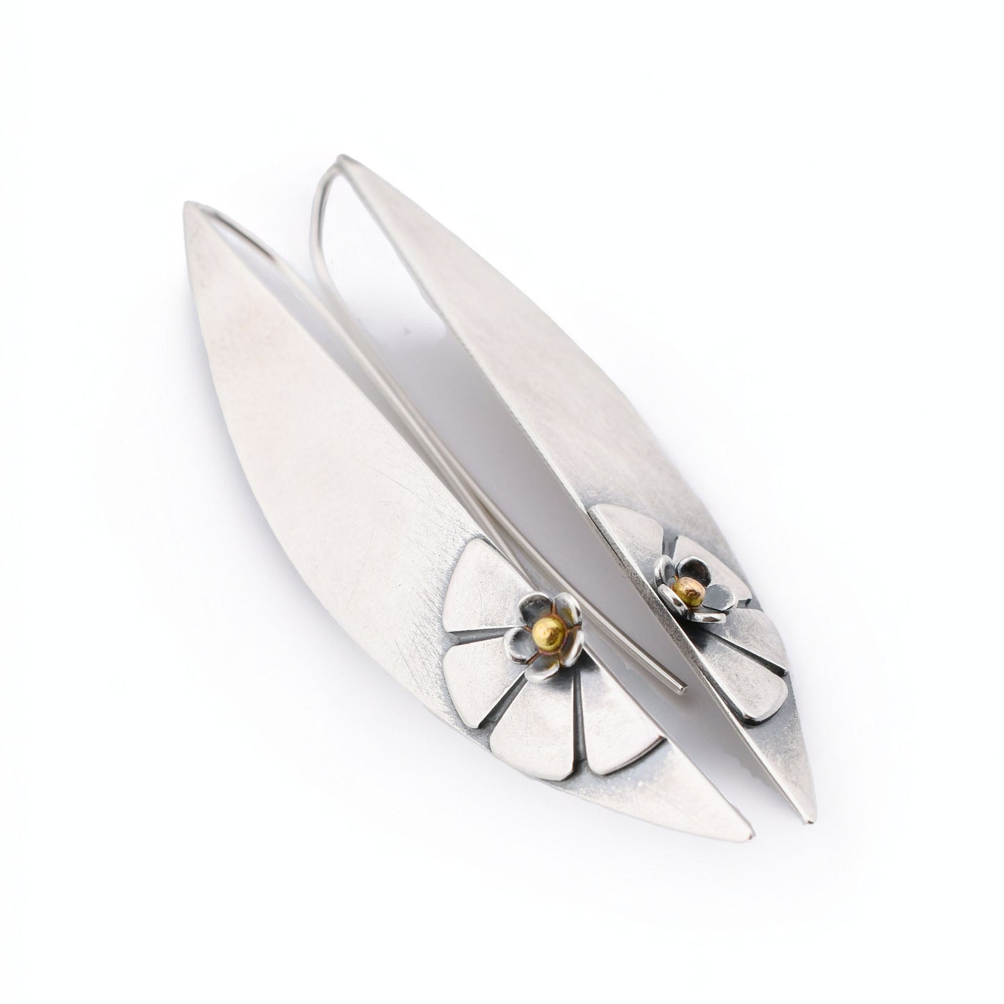 Silver earrings with a floral design on a white background