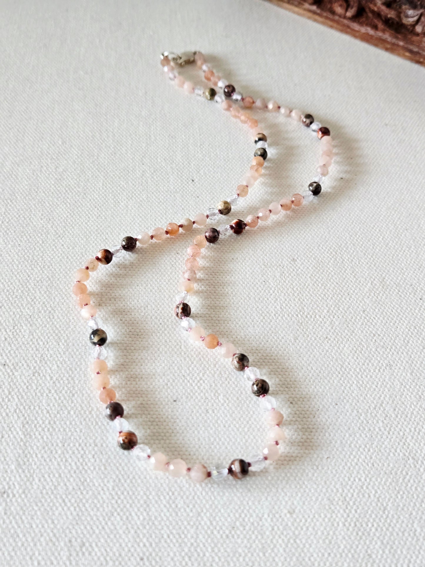 Beaded necklace on a light fabric background
