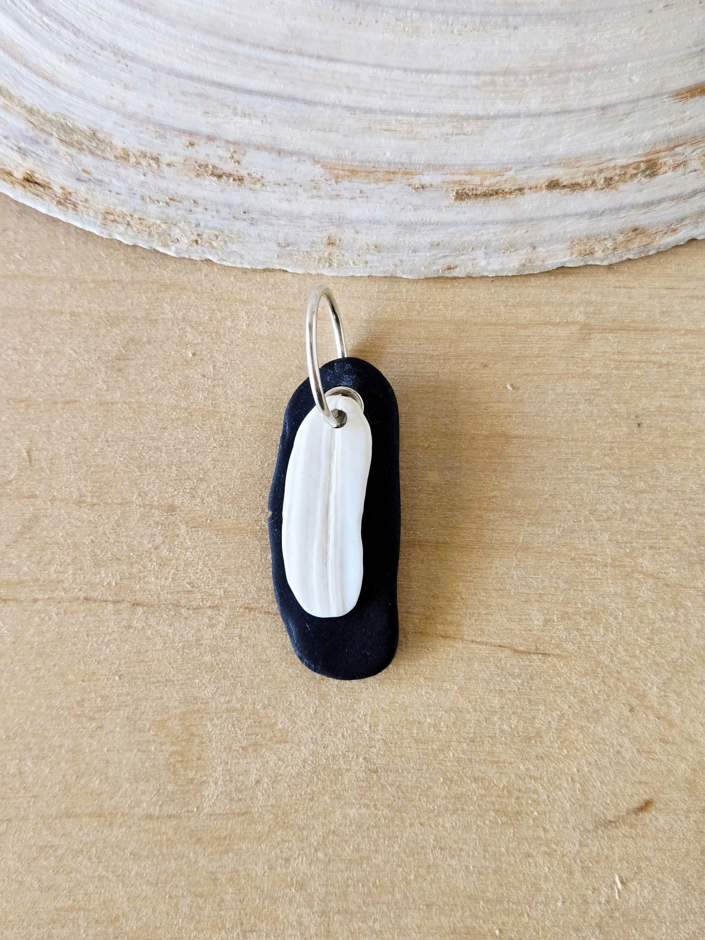 Black Beach Stone & White Shell Charm
