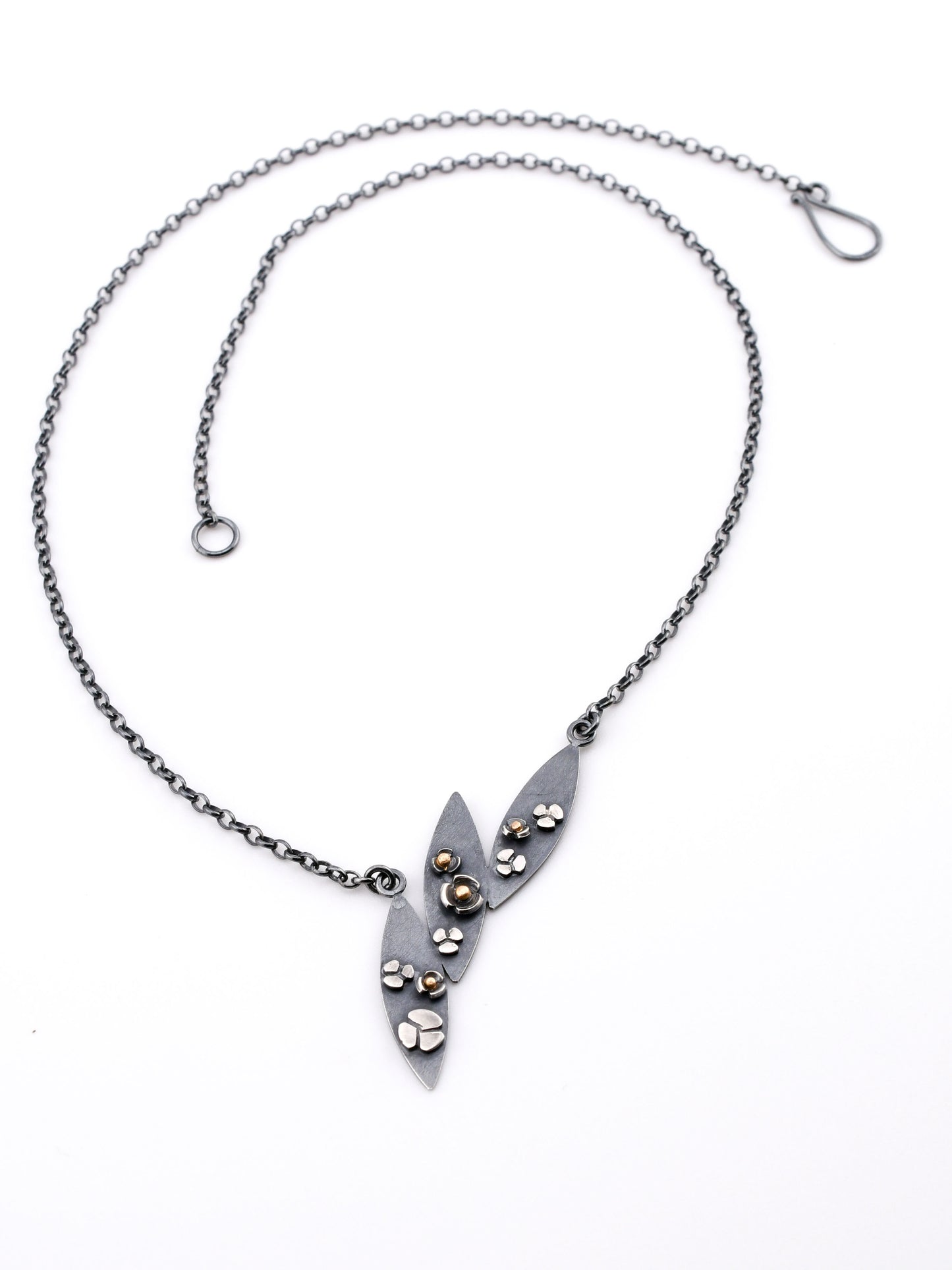 3 leaf necklace with flowers and gold accents on a white background
