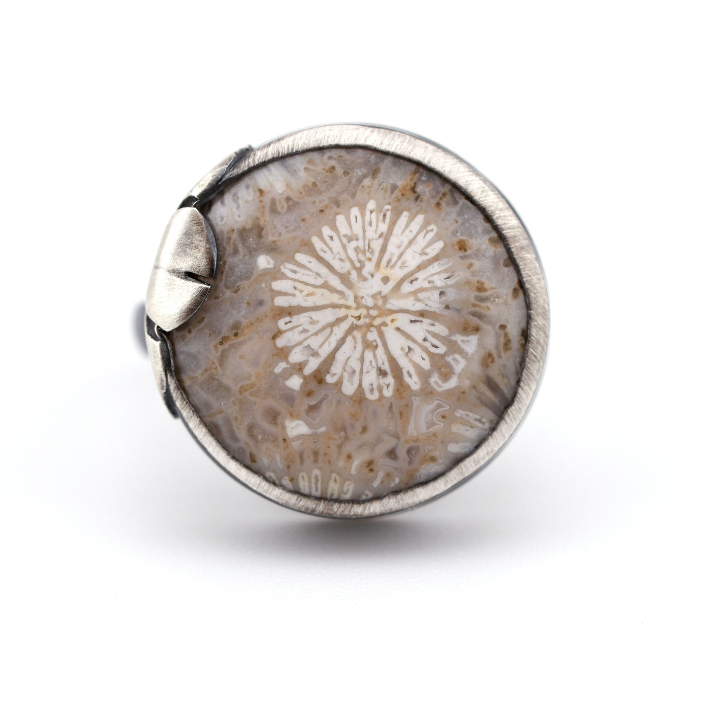 Silver ring with a Floral design on a white background