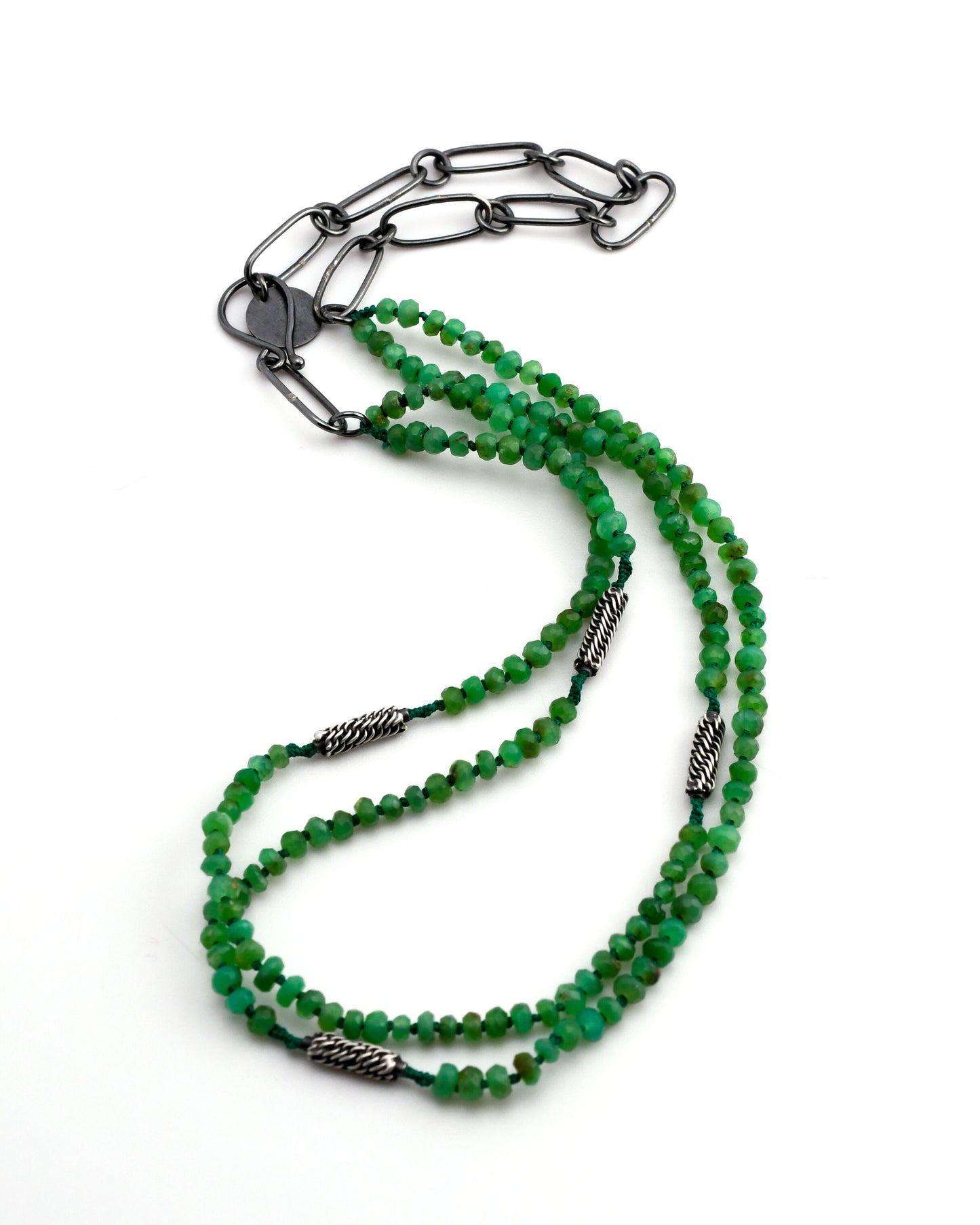 green chrysoprase double strand necklace with woven silver bead accents and black silver chain on a white background