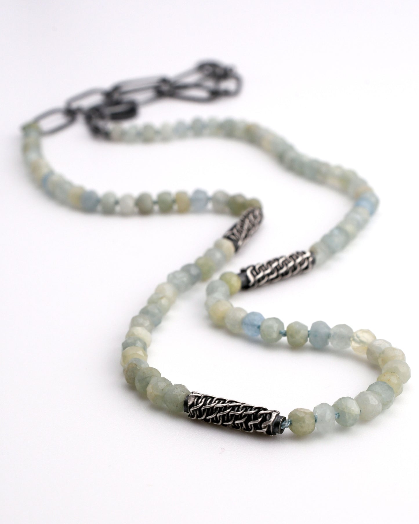 natural blue aquamarine beaded necklace with woven silver bead accents and black silver chain extender on a white background