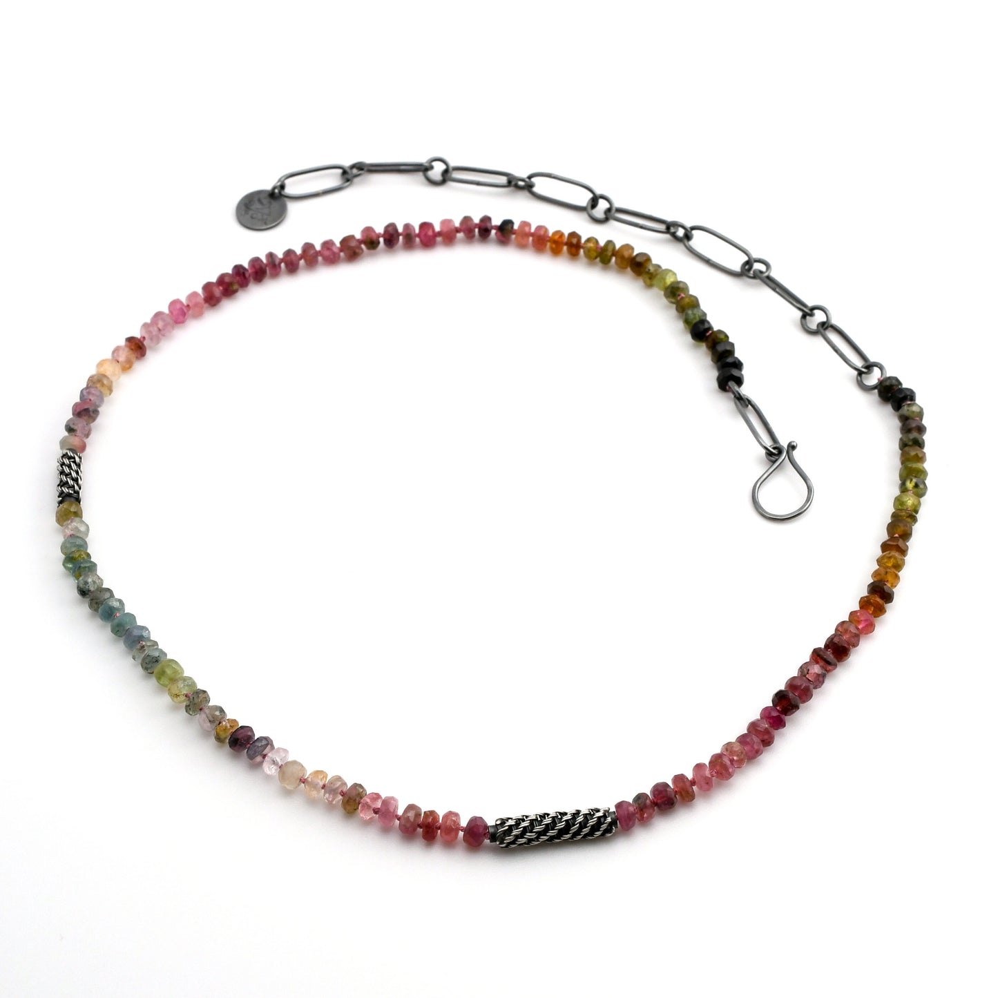 multi-color natural tourmaline beaded necklace with woven silver bead accents and black silver chain extender on a white background