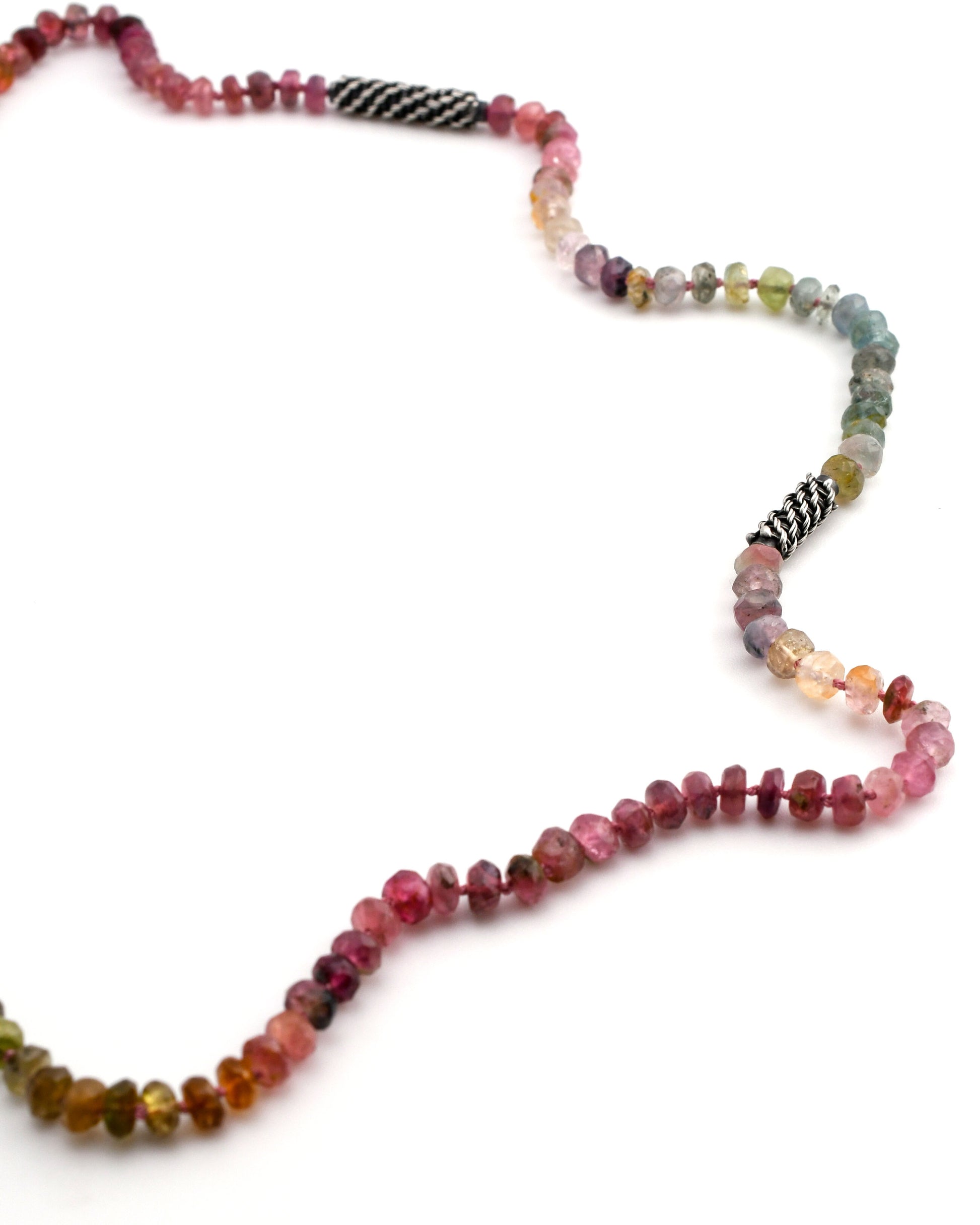 Multicolored tourmaline beaded necklace with woven silver bead accents on a white background