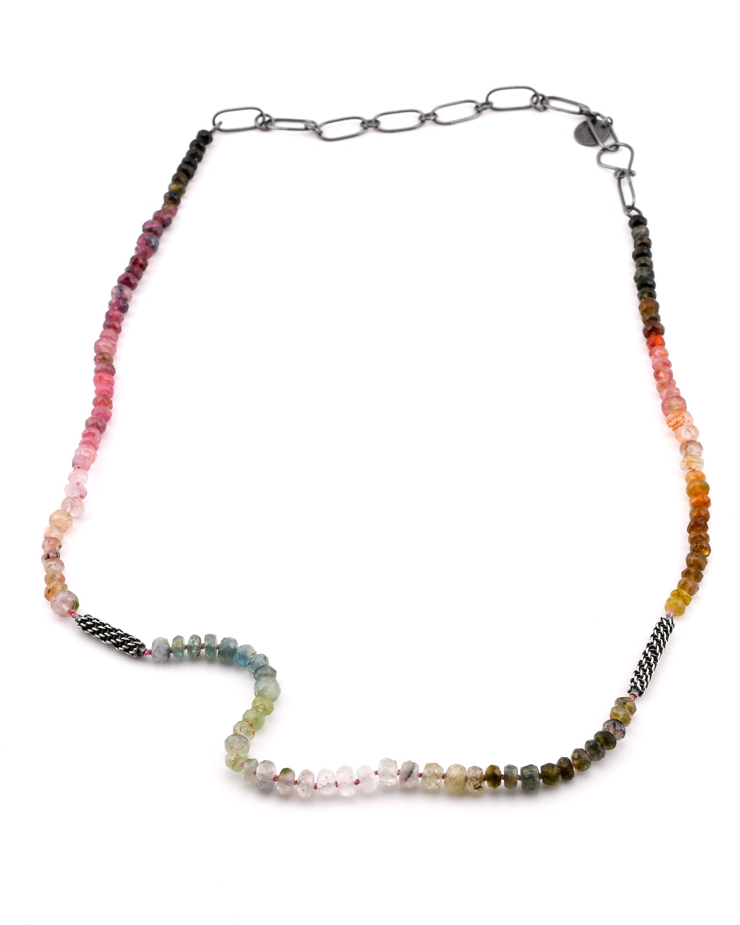 colorful tourmaline beaded necklace with woven silver elements and silver chain extender on a white background