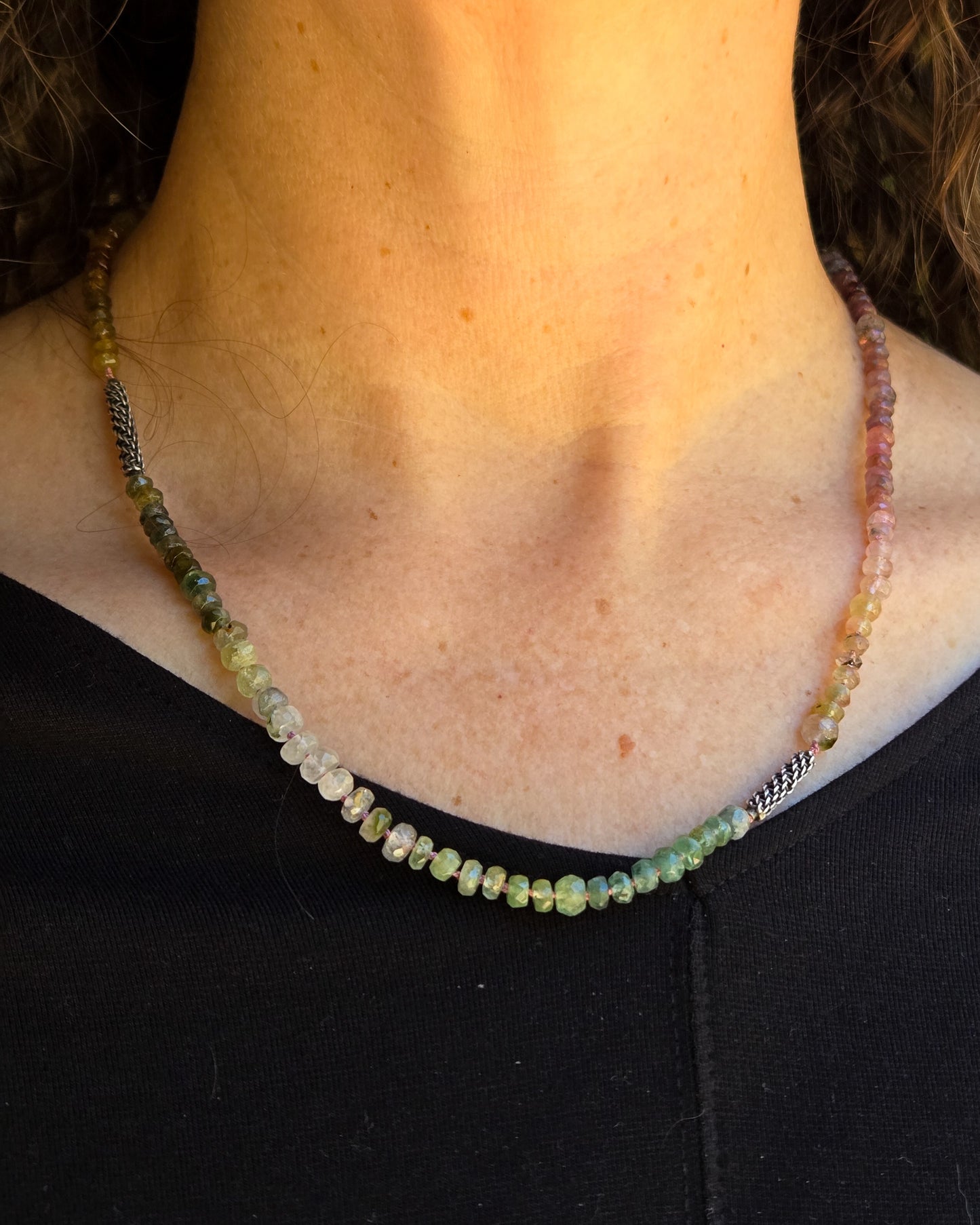tourmaline beaded necklace with woven silver elements shown worn at its shortest length