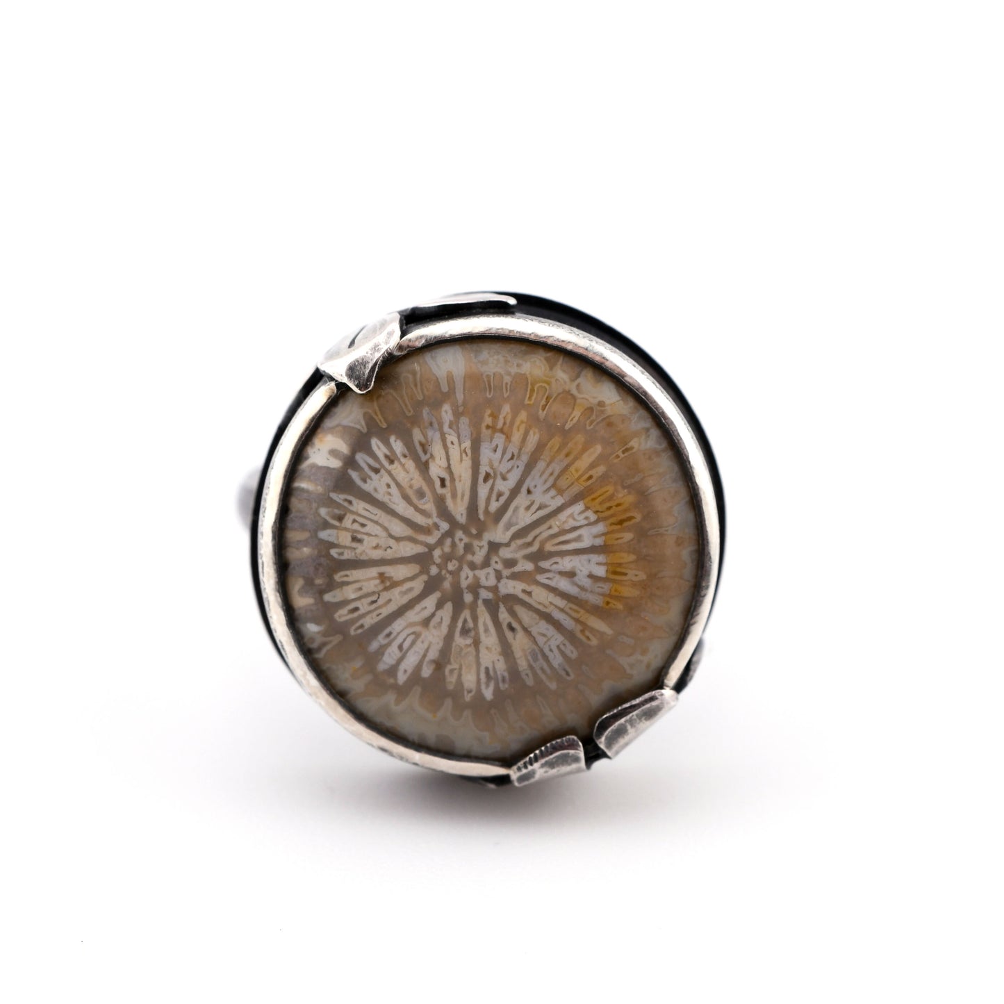 Round silver ring with a natural stone on a white background