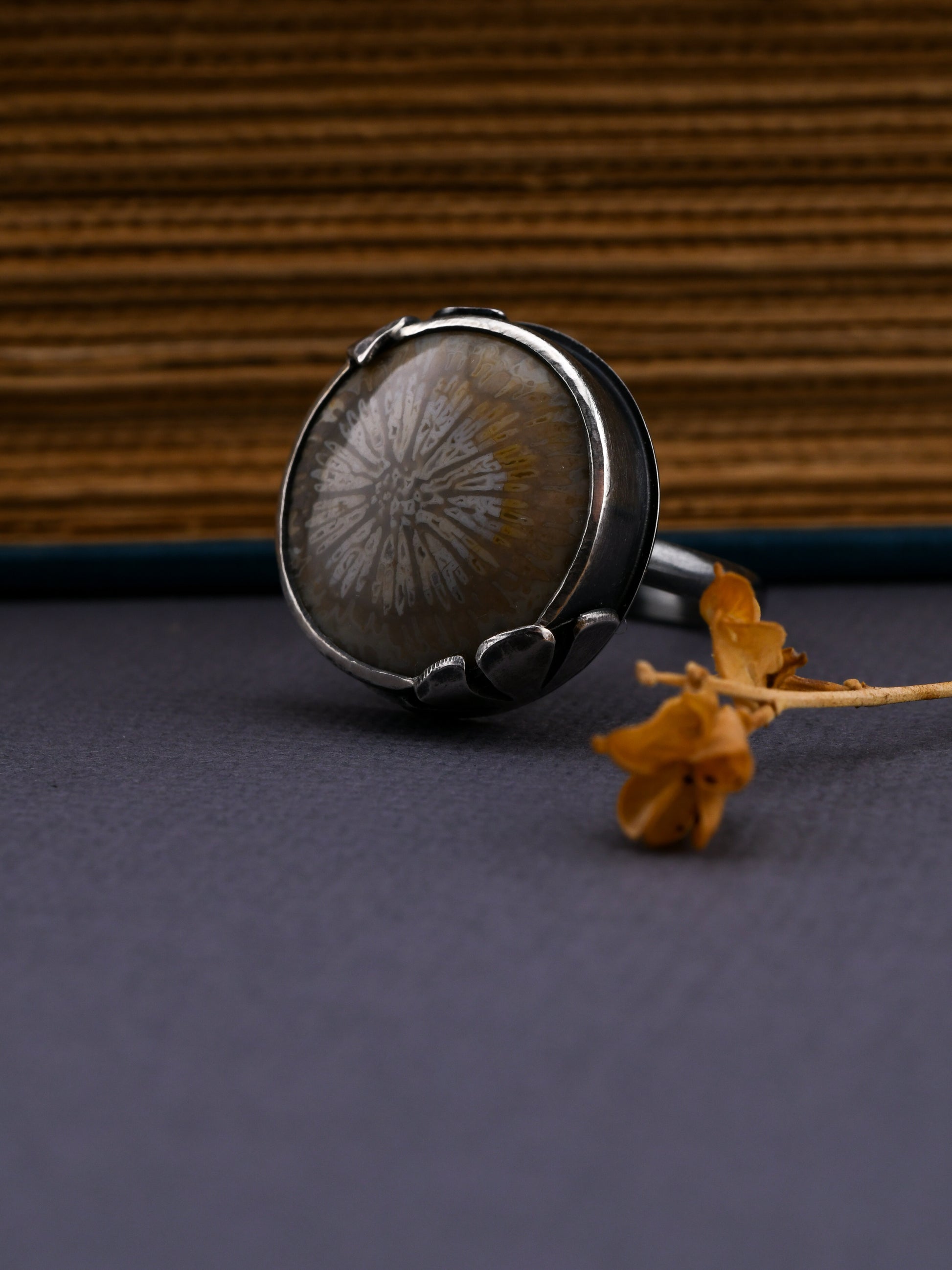 Silver ring with a natural stone on a textured surface
