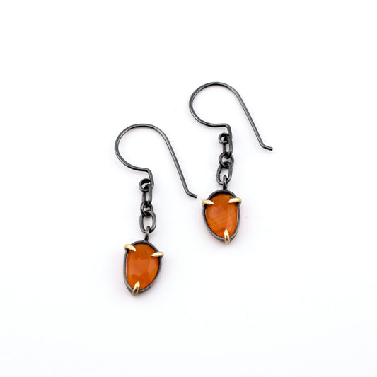 blackened silver carnelian earrings with chain and gold accents on a white background