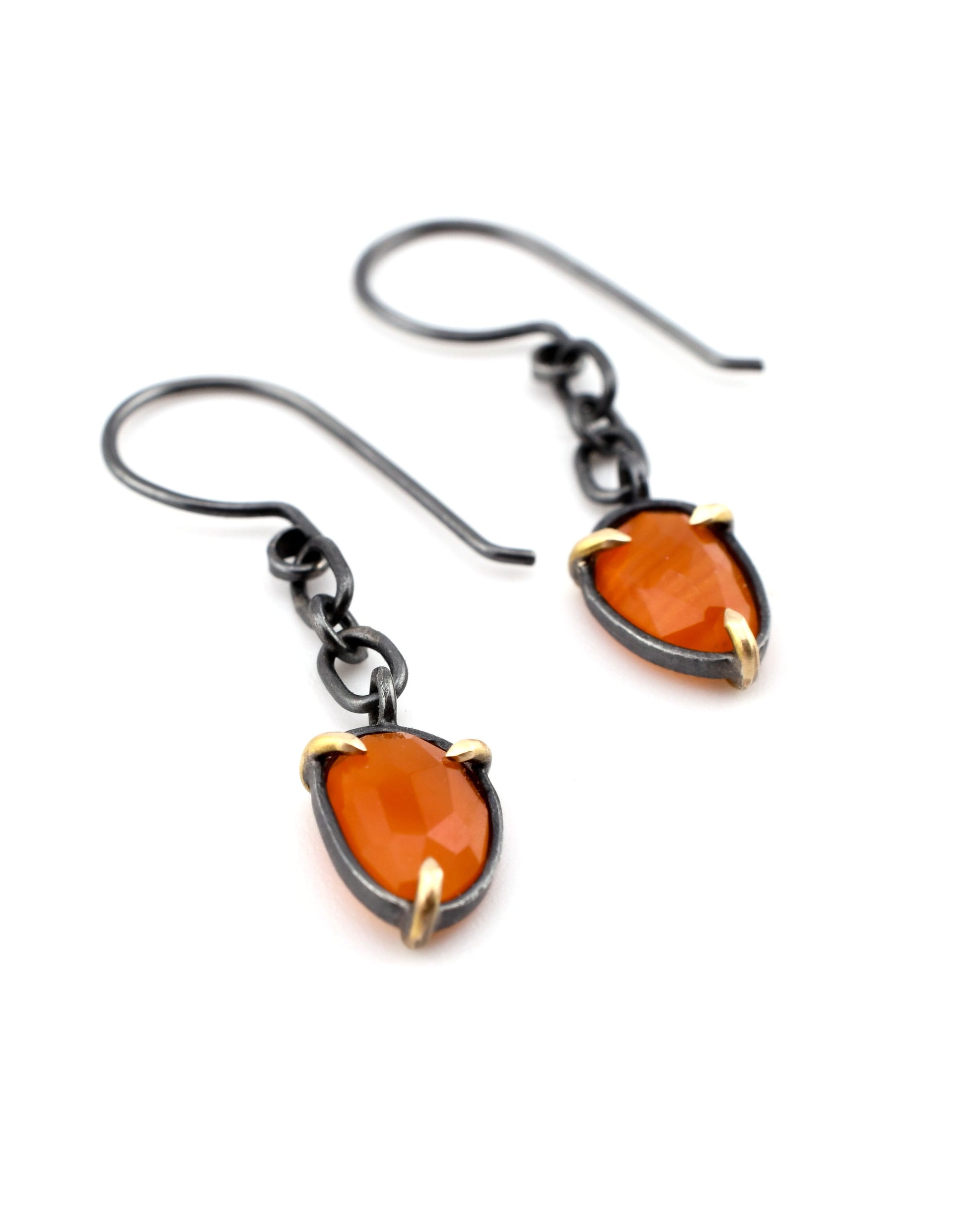 carnelian earrings with blackened silver chain details and 14k gold prongs on a white background
