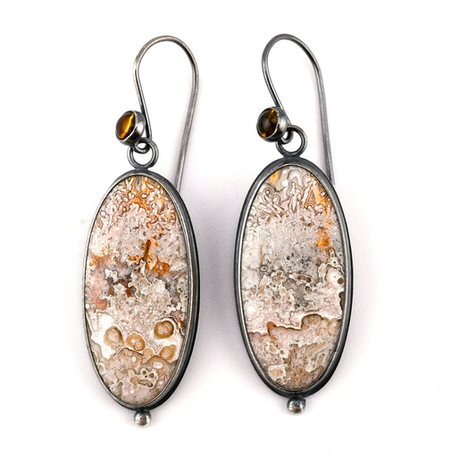 Pair of earrings with natural stone design on a white background