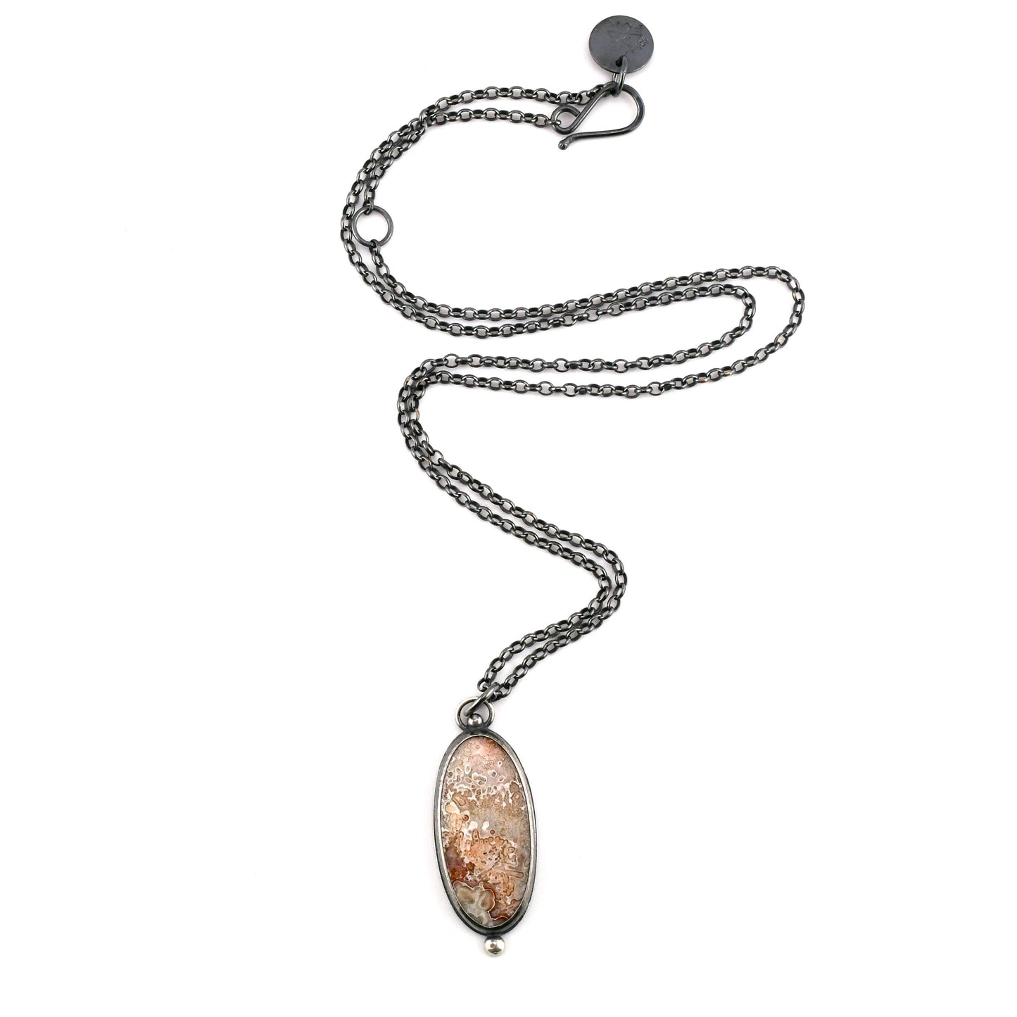 Necklace with an oval pendant on a white background