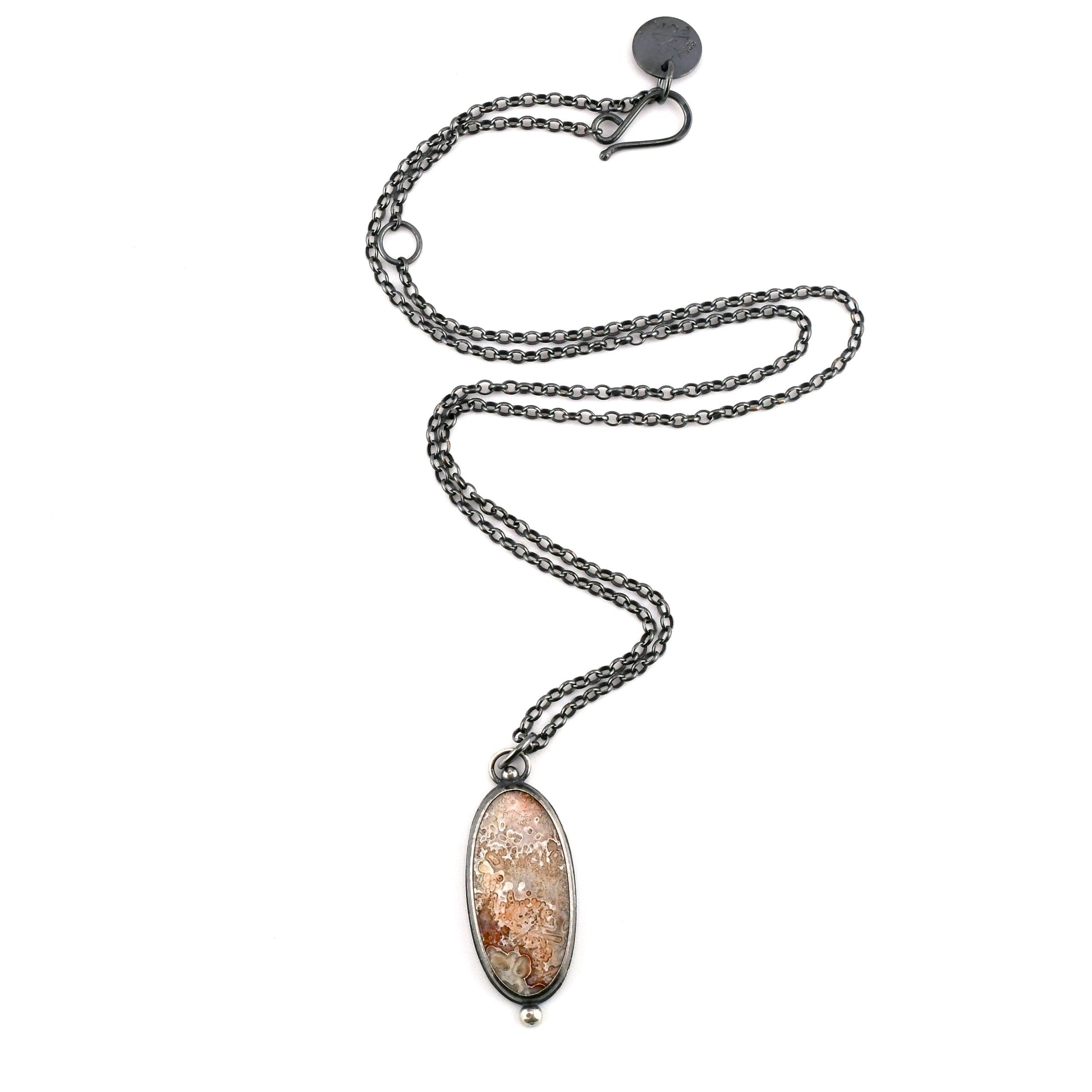 Necklace with an oval pendant on a white background