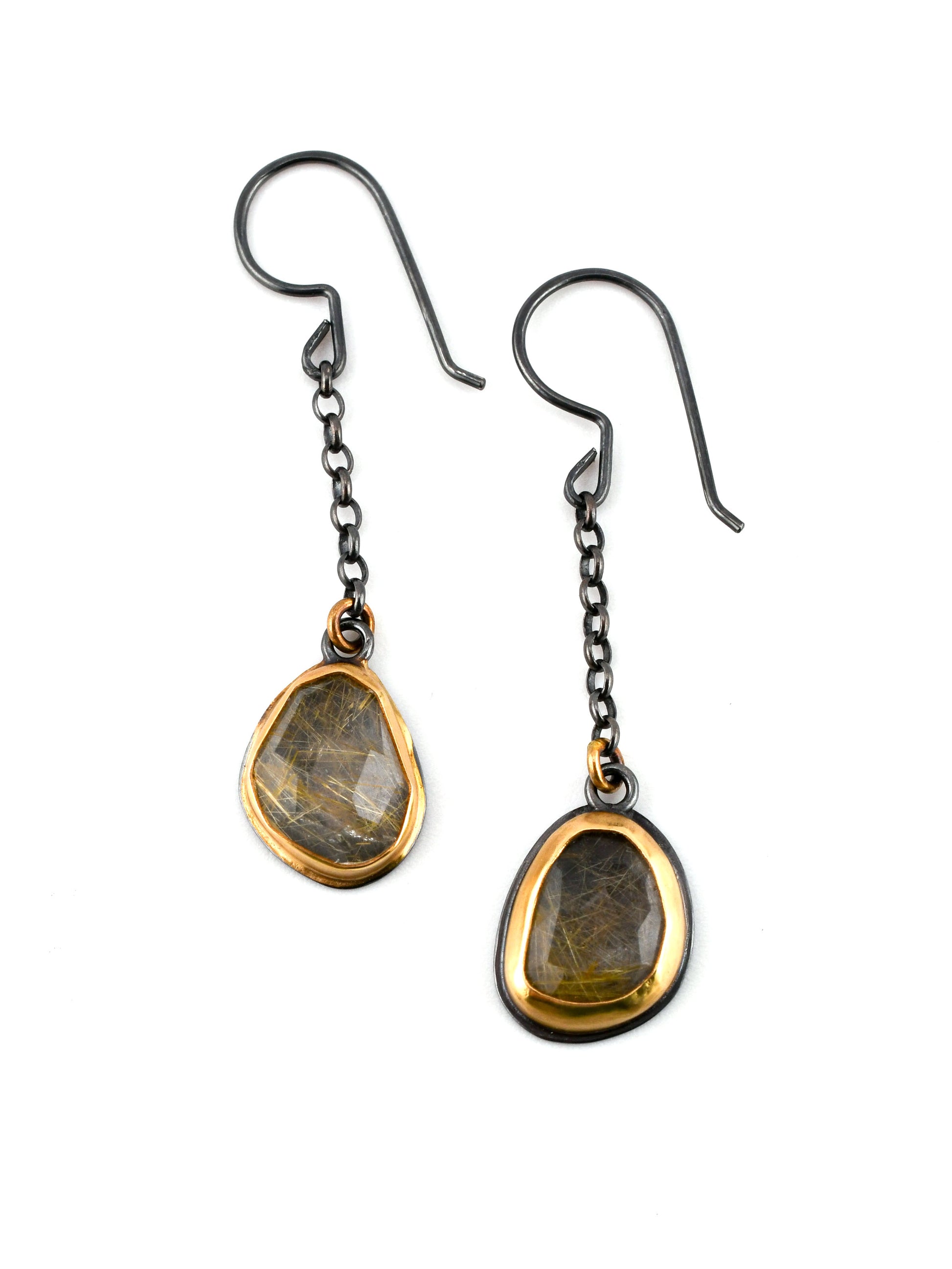 Pair of earrings with teardrop-shaped gemstones on a white background
