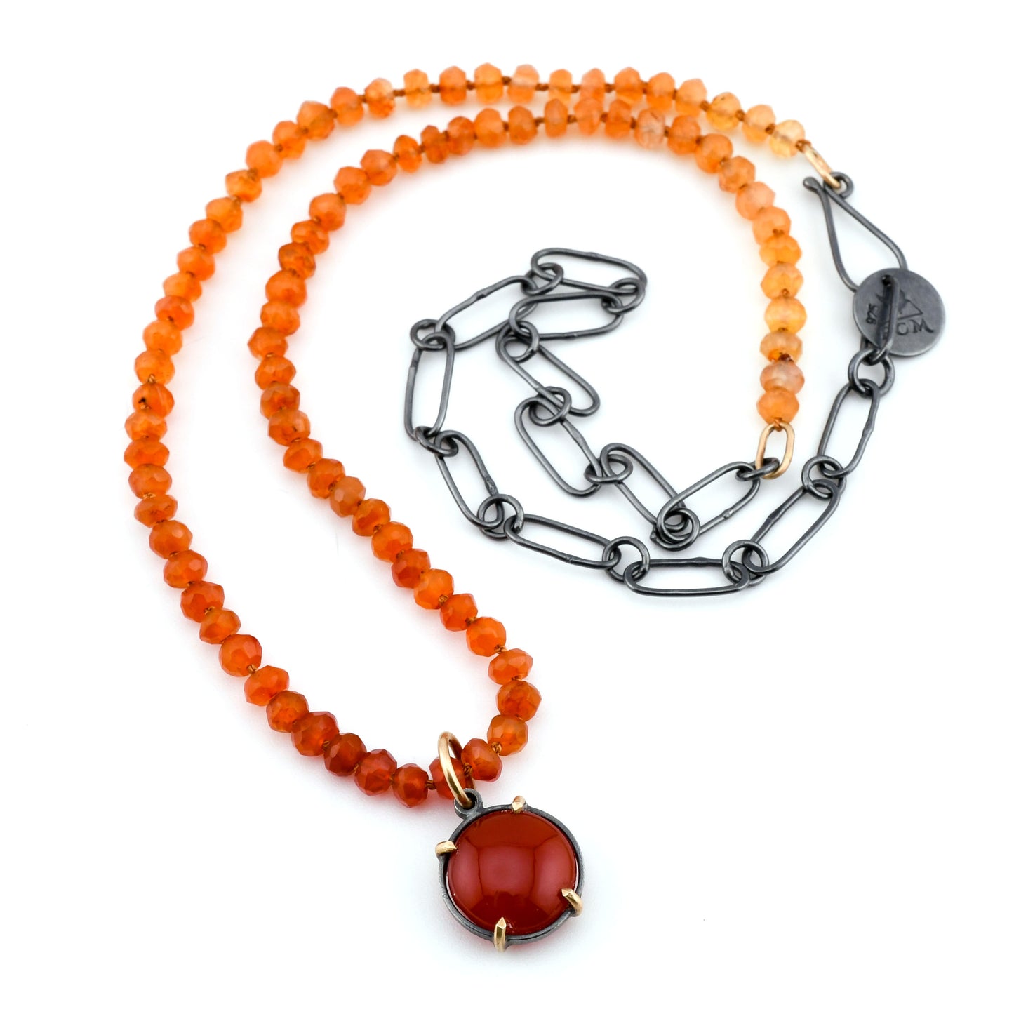 Necklace with orange beads and a red pendant on a white background