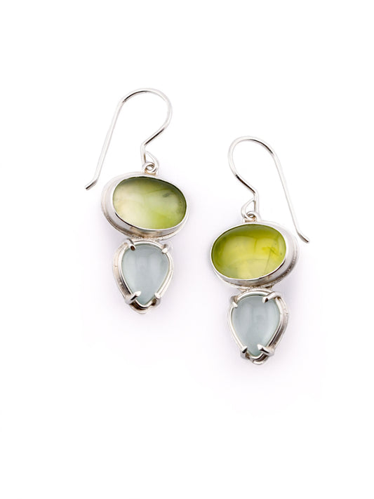 Pair of earrings with green and light blue stones on a white background