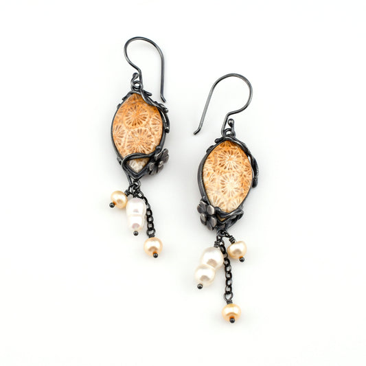 gold and cream fossil coral earrings with blackened silver vine and flower details and pearl drops displayed on a white background
