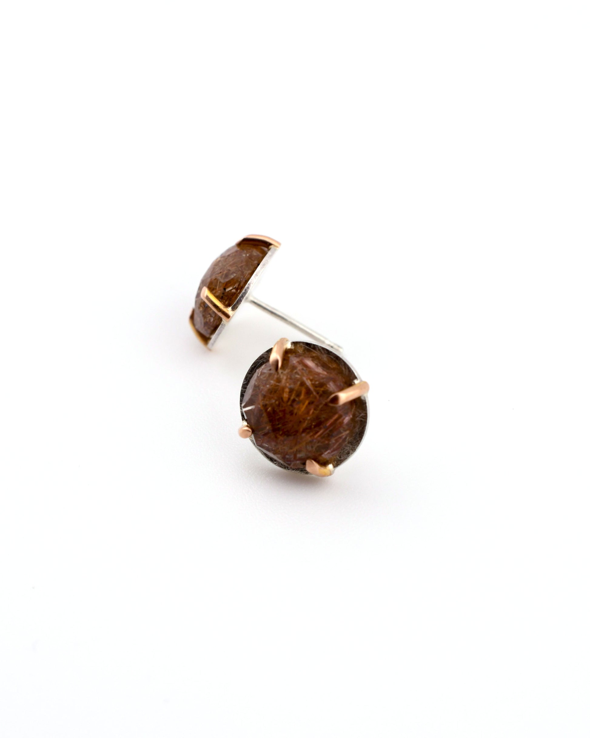 silver and rose gold studs with rutilated quartz on a white background