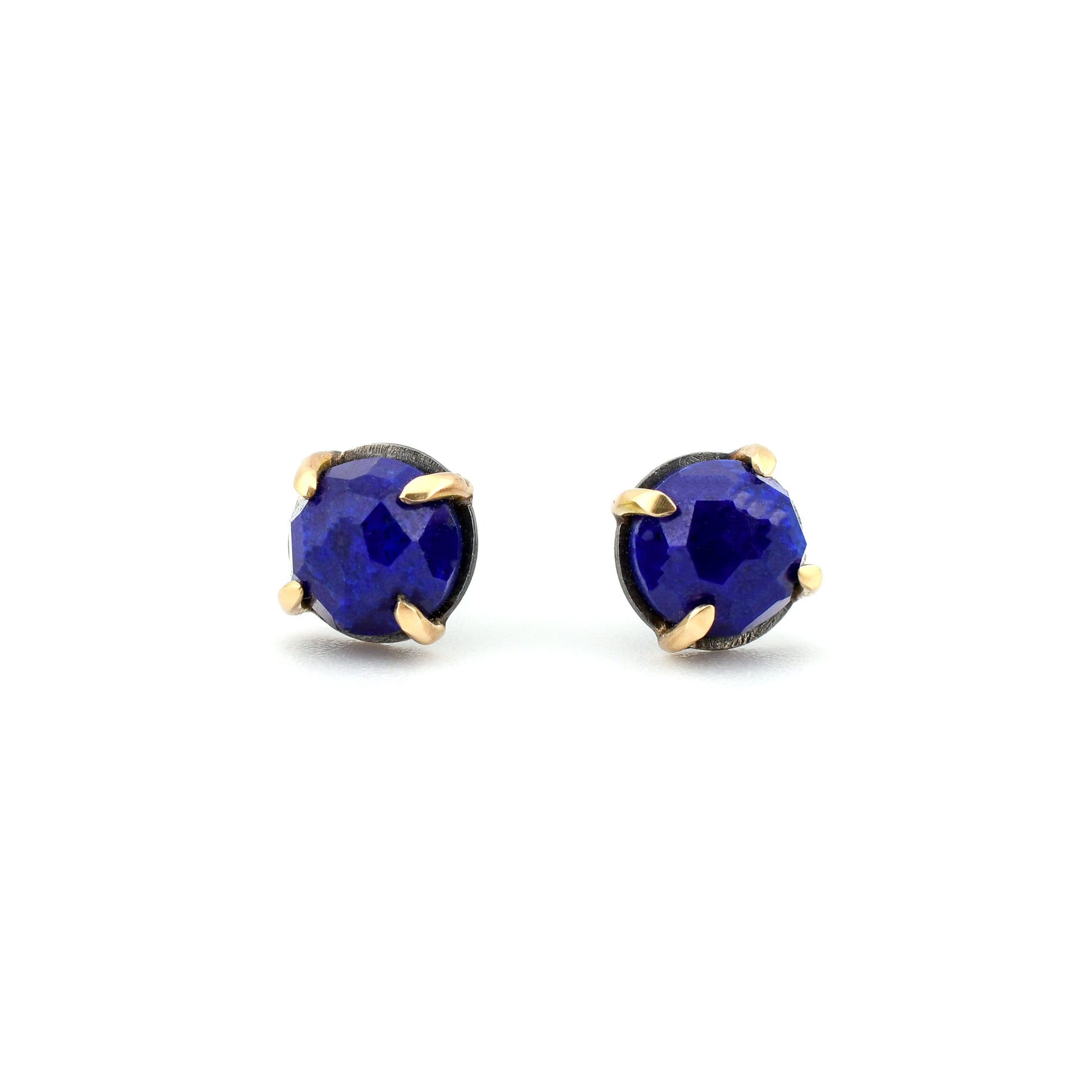 royal blue lapis stud earrings in black silver and yellow gold on a white background