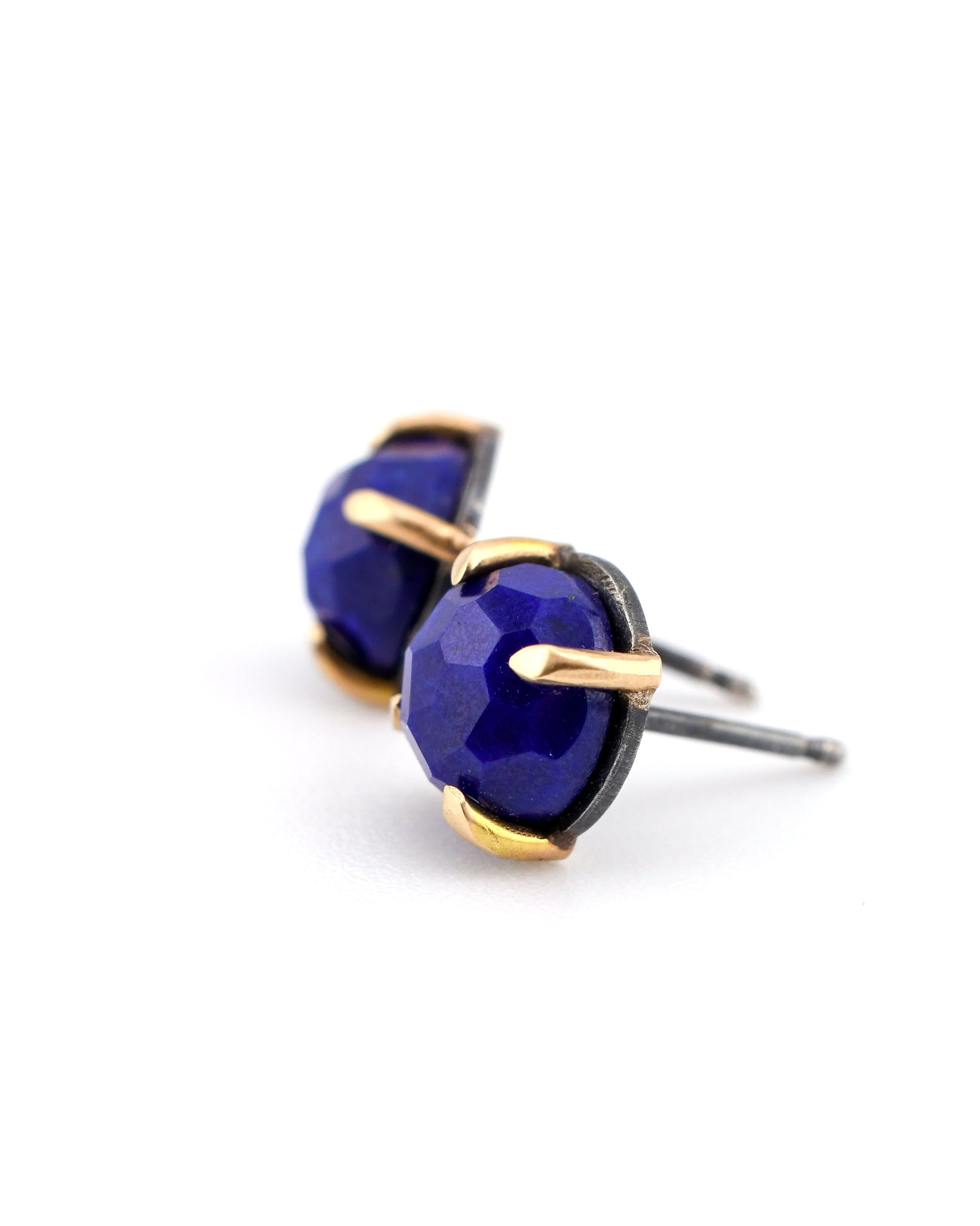 blackened silver and 14k gold stud earrings with lapis on a white background