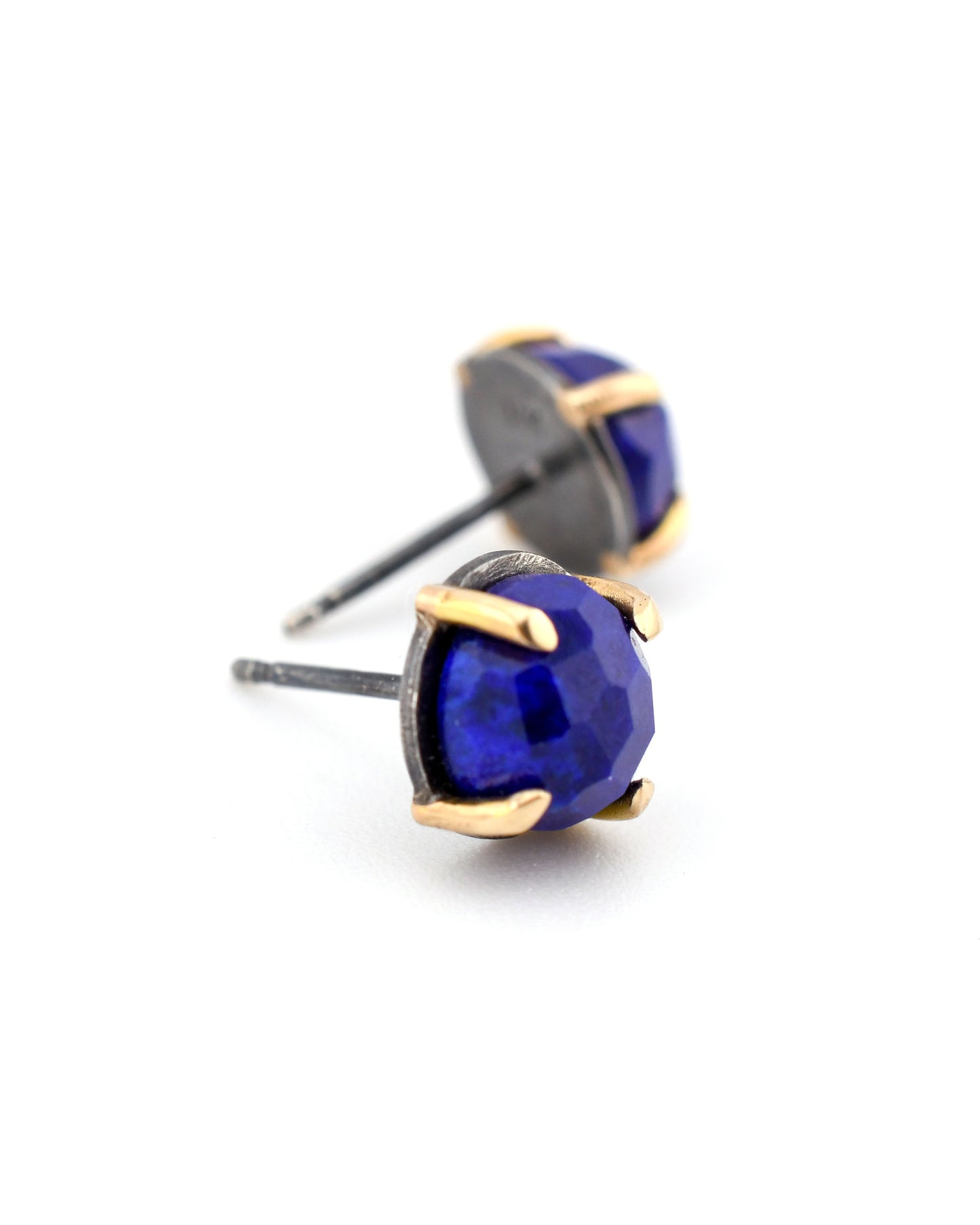 blue lapis stud earrings in black silver and 14k gold on a white background