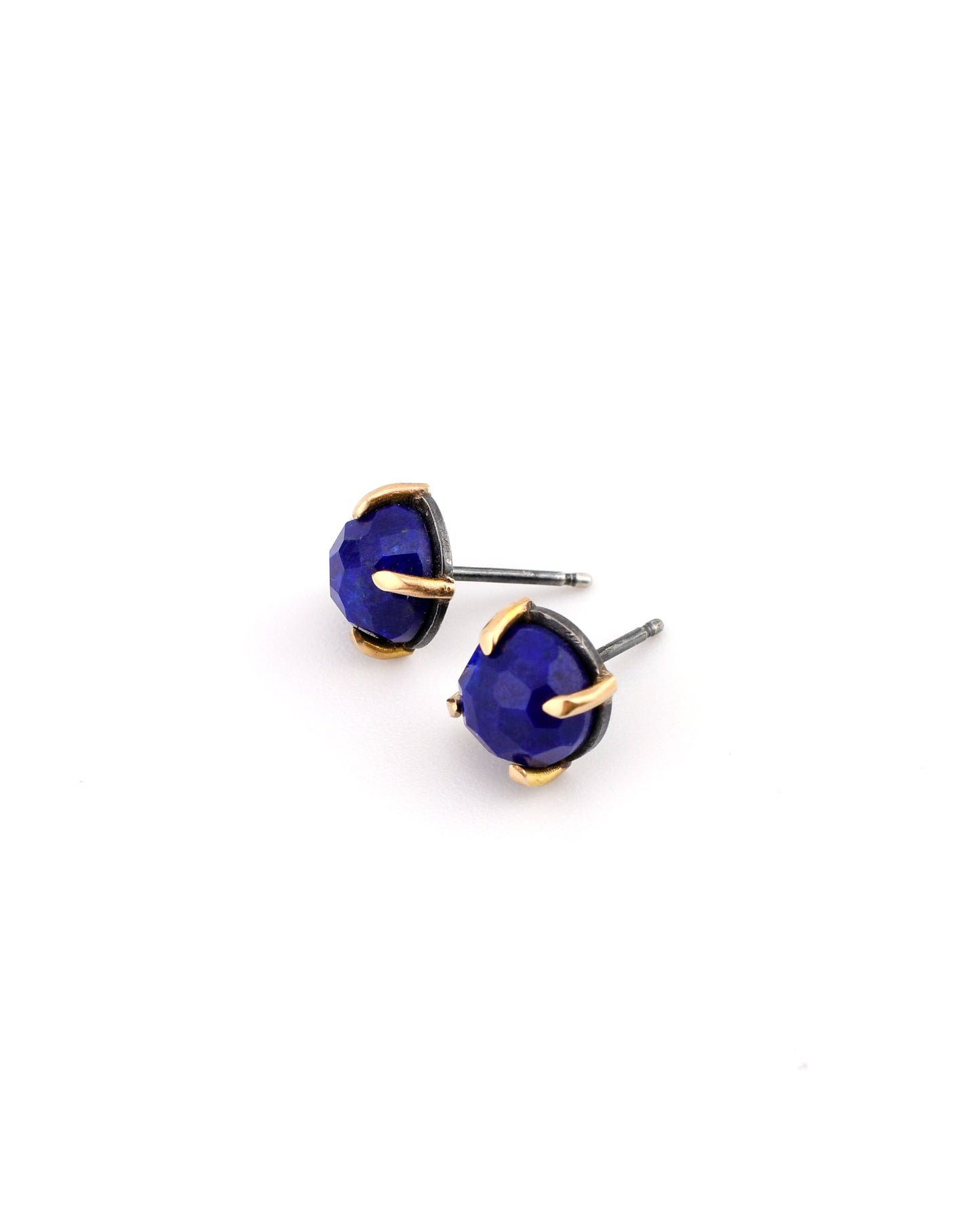 blue lapis studs in blackened silver and 14k gold on a white background