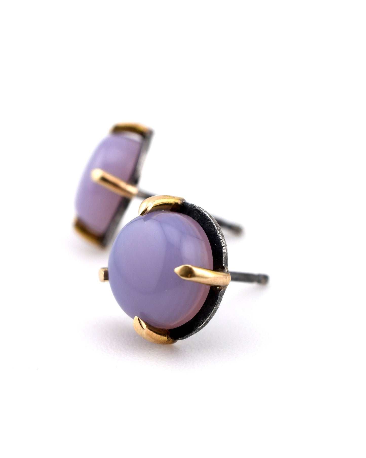 lilac chalcedony studs in black silver and yellow gold on a white background