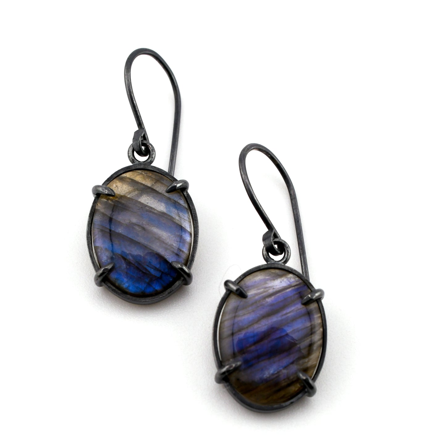 Pair of earrings with blue and gray stone on a white background