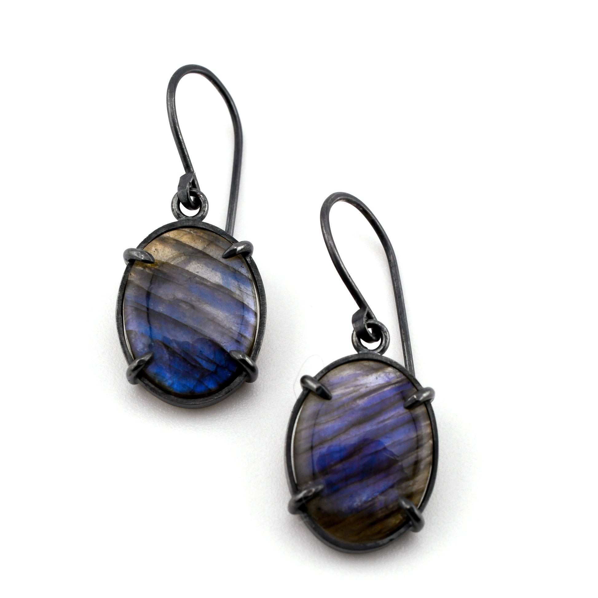 Pair of earrings with blue and gray stone on a white background