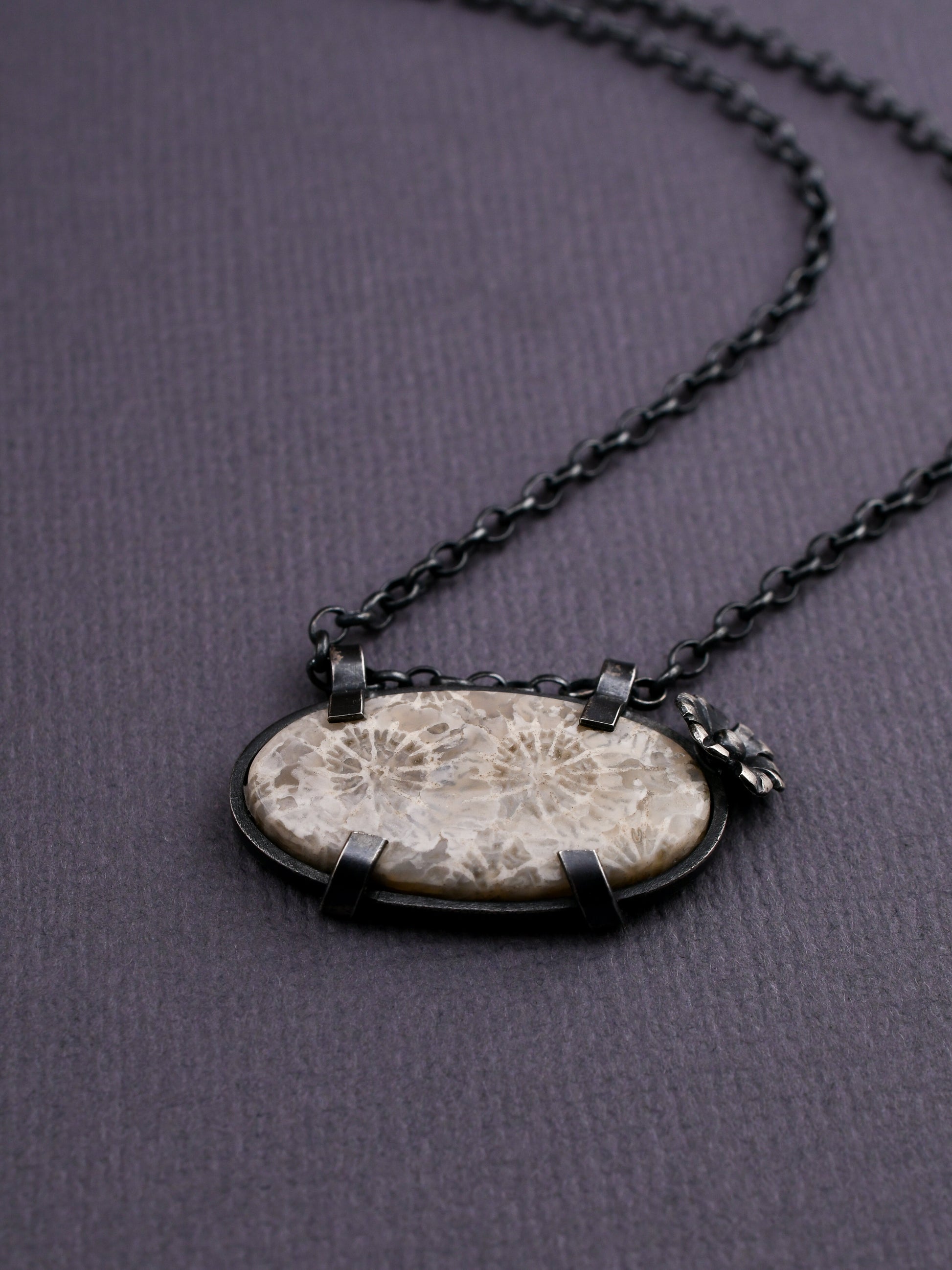 Necklace with a stone pendant on a dark gray background