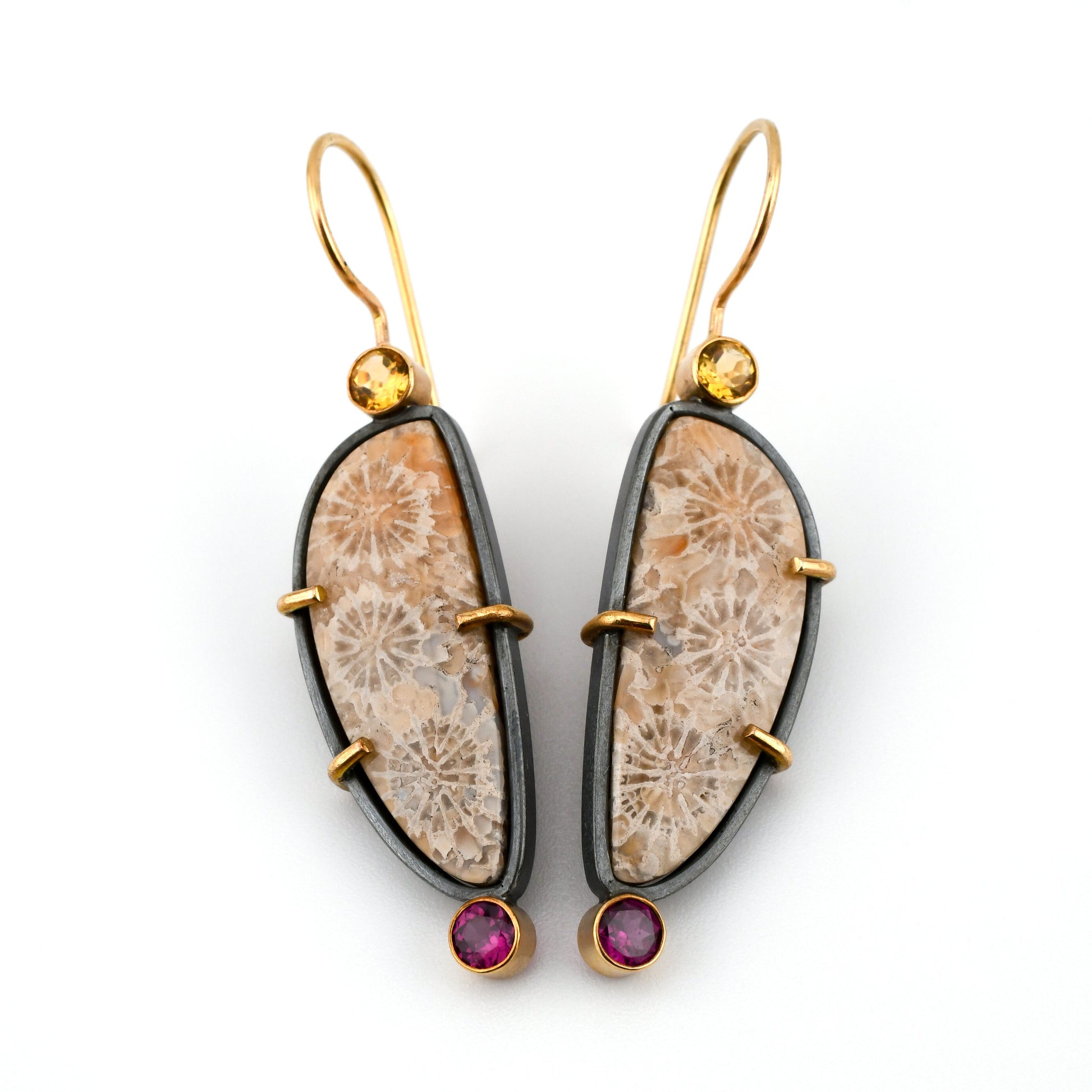 Coral earrings in soft pastel colors with black silver frames and gold ear wires and accents and faceted gemstones on a white background