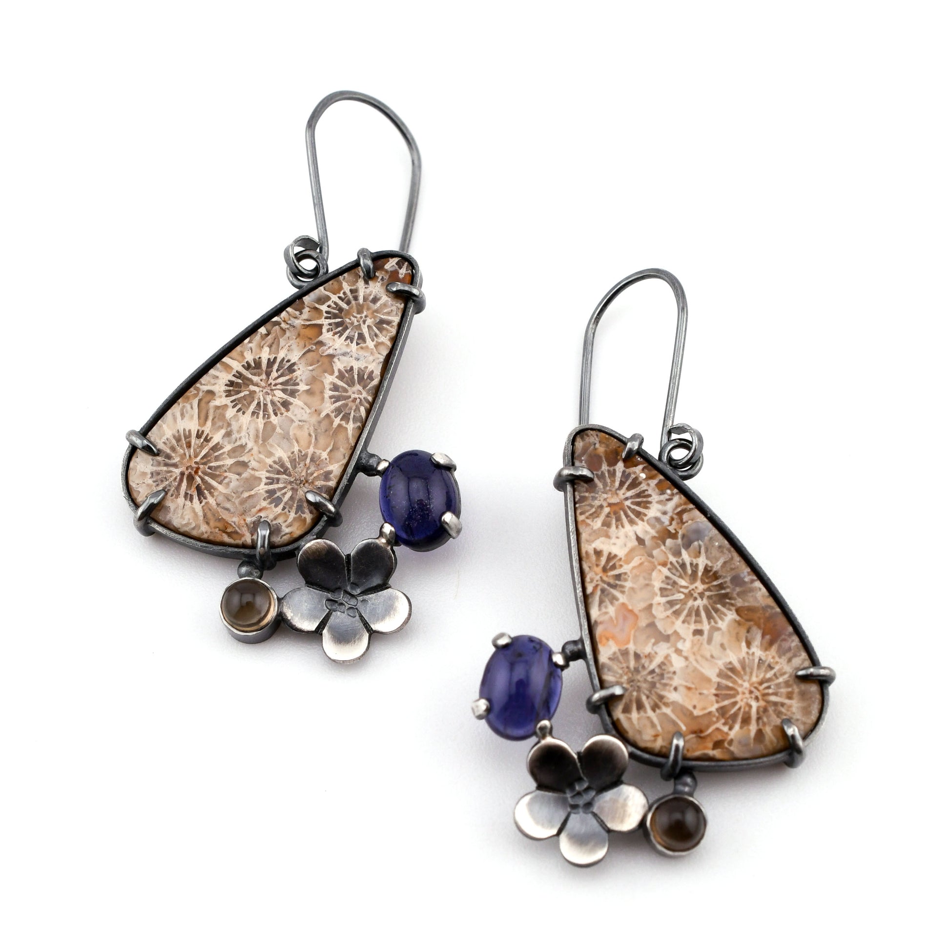 Pair of earrings with floral and gemstone designs on a white background