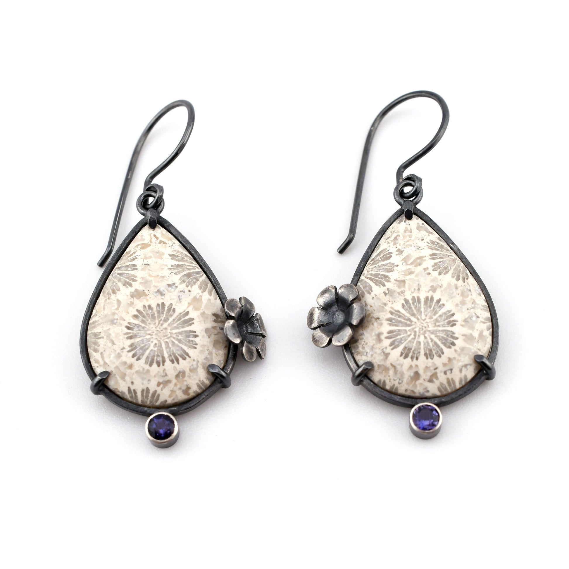 Teardrop-shaped earrings with floral designs and gemstones on a white background