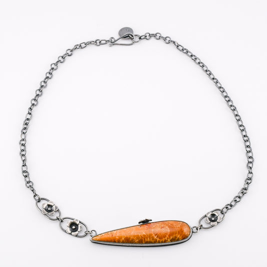 Necklace with silver flower elements and long golden fossil coral pendant