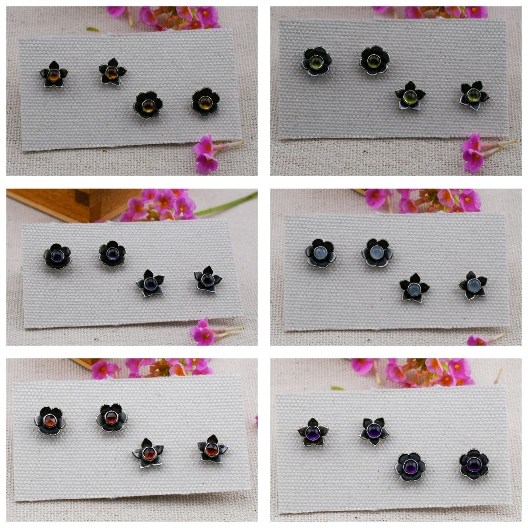 Six-panel collage showing small flower-shaped stud earrings displayed on white fabric cards. The earrings have black petals with colorful centers in yellow, green, blue, red, and purple, with small pink flowers in the background.