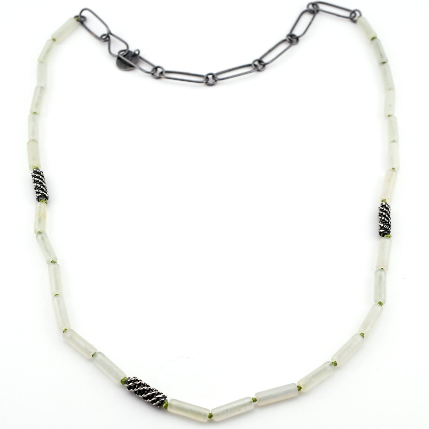 Necklace with pale green beads and black accents on a white background
