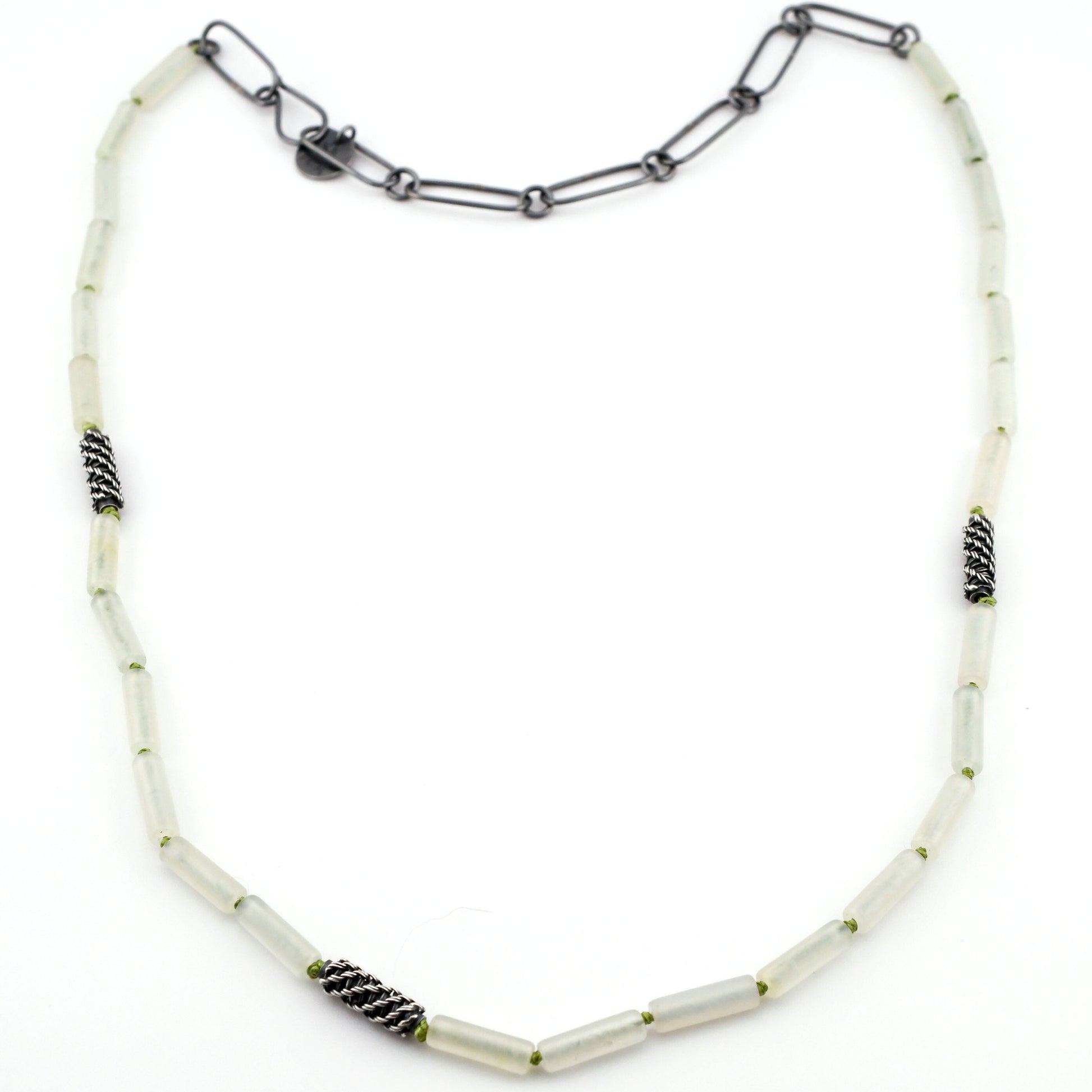 Necklace with pale green beads and black accents on a white background