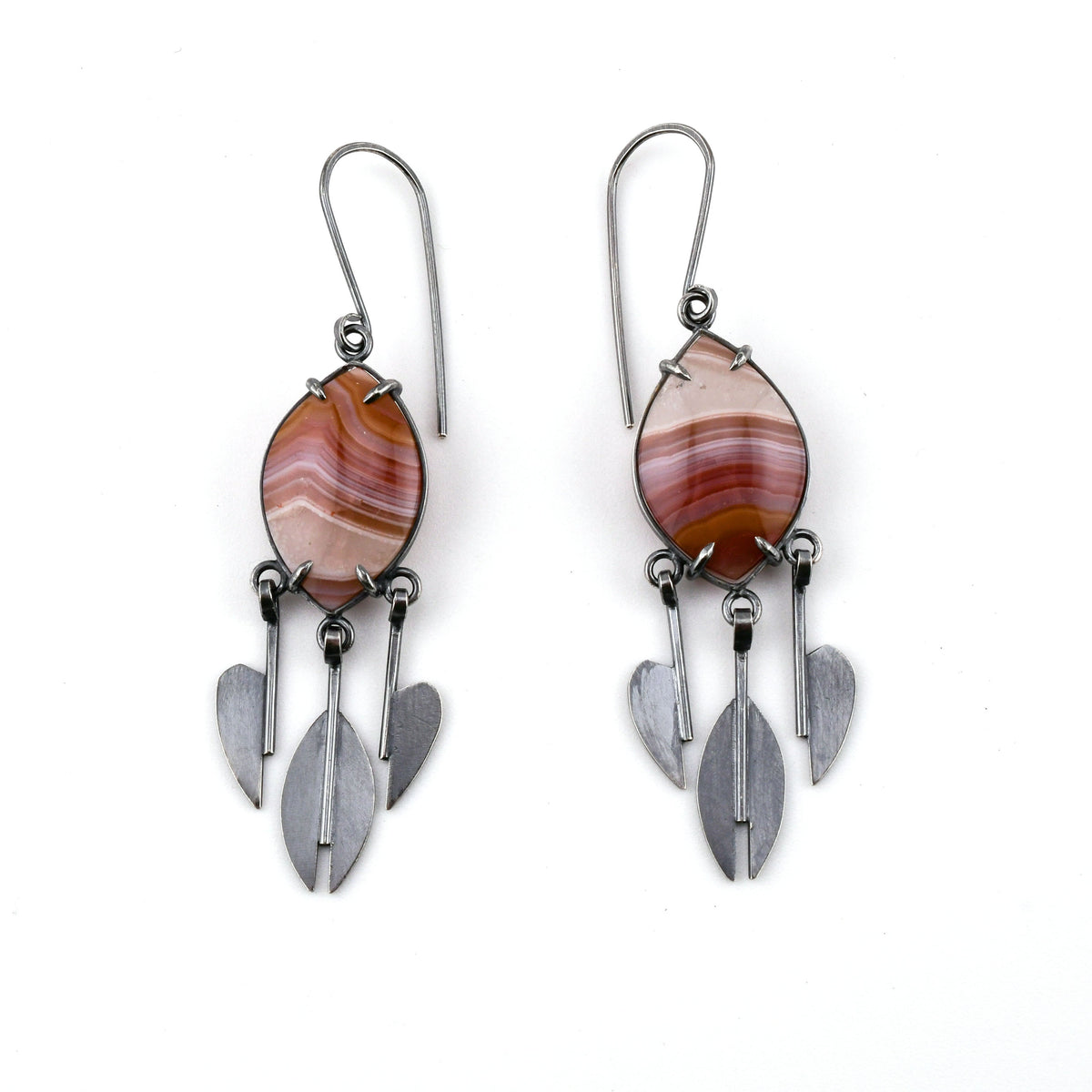Pair of Laguna lace agate earrings in stripes of purple and dark gold set in silver with stylized raindrop pendants at the bottom shown on a white background