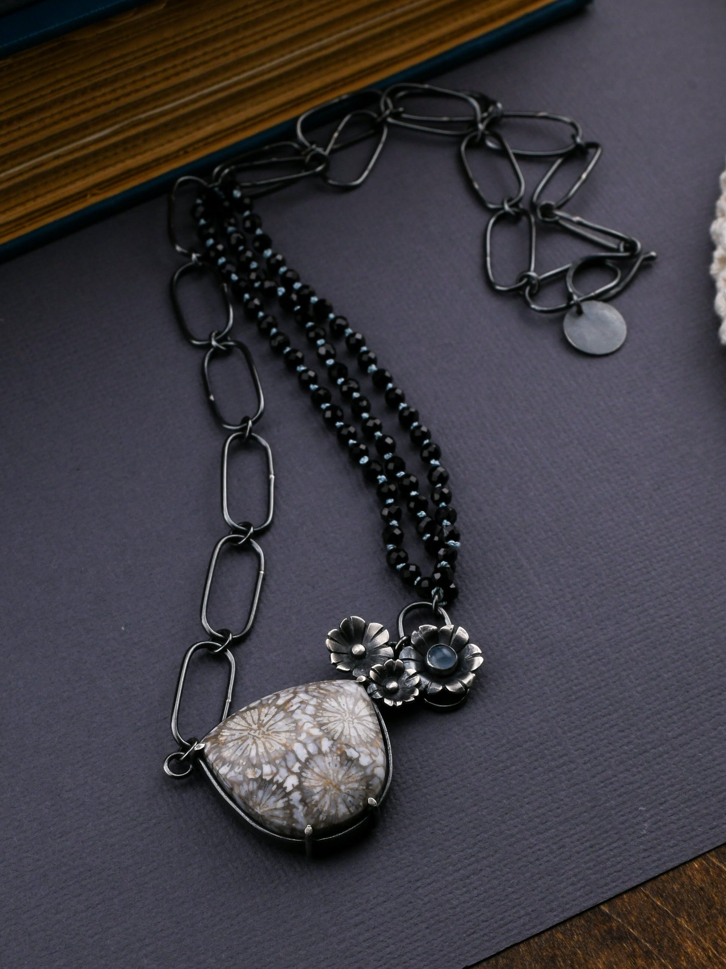 Necklace with a large stone pendant on a dark surface