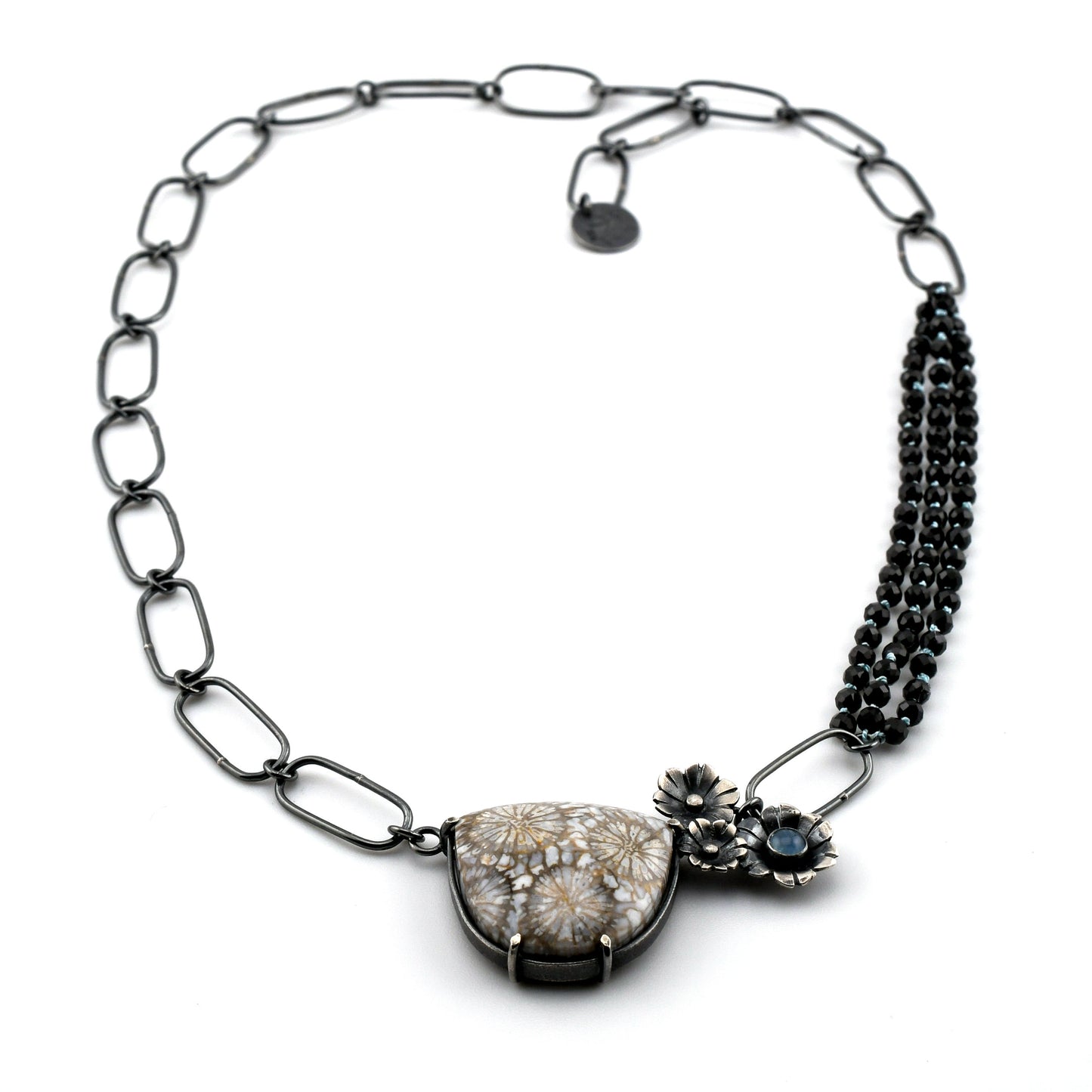 Necklace with floral design and gemstones on a white background