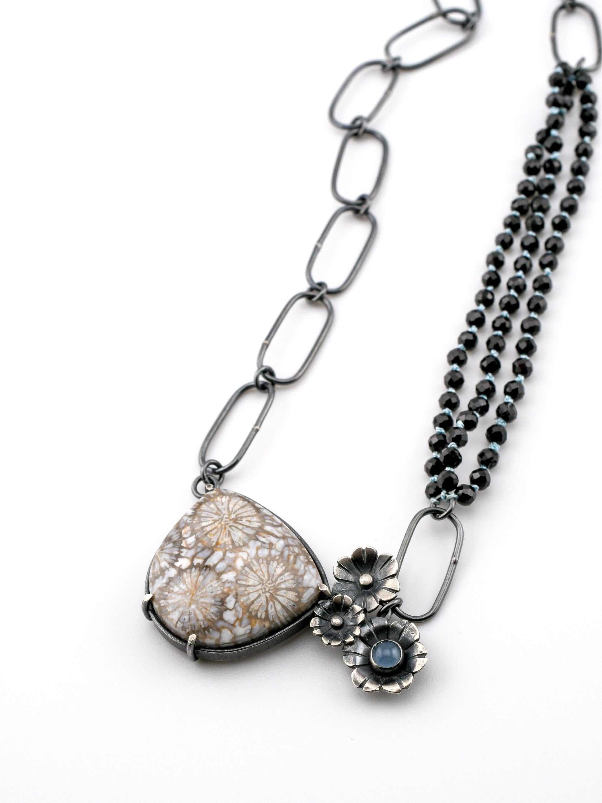 Necklace with floral pendant and chain on a white background