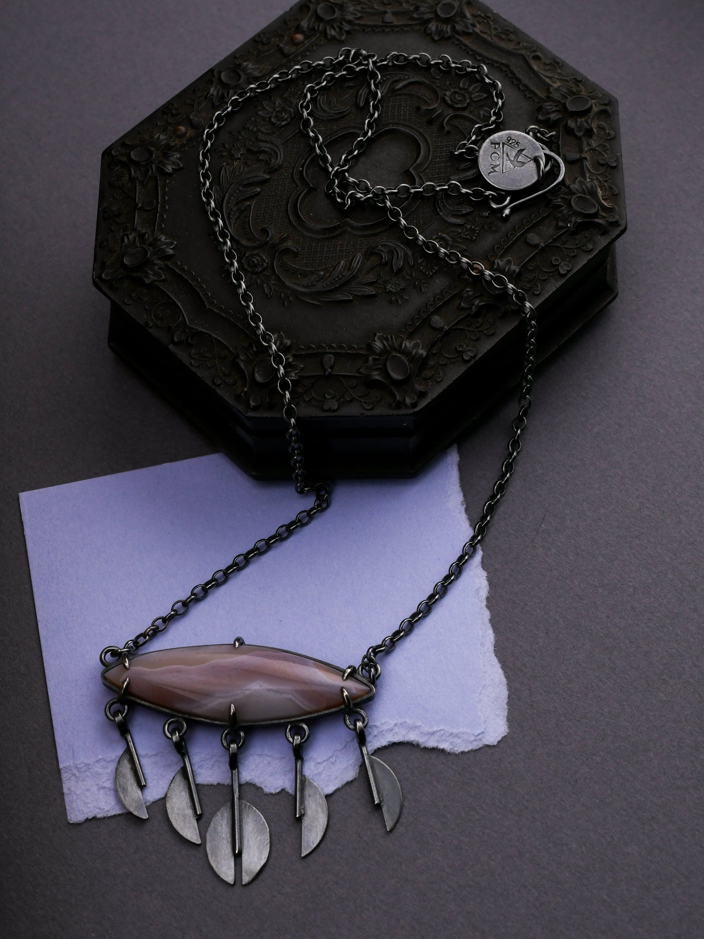 Necklace with a pendant on a dark surface