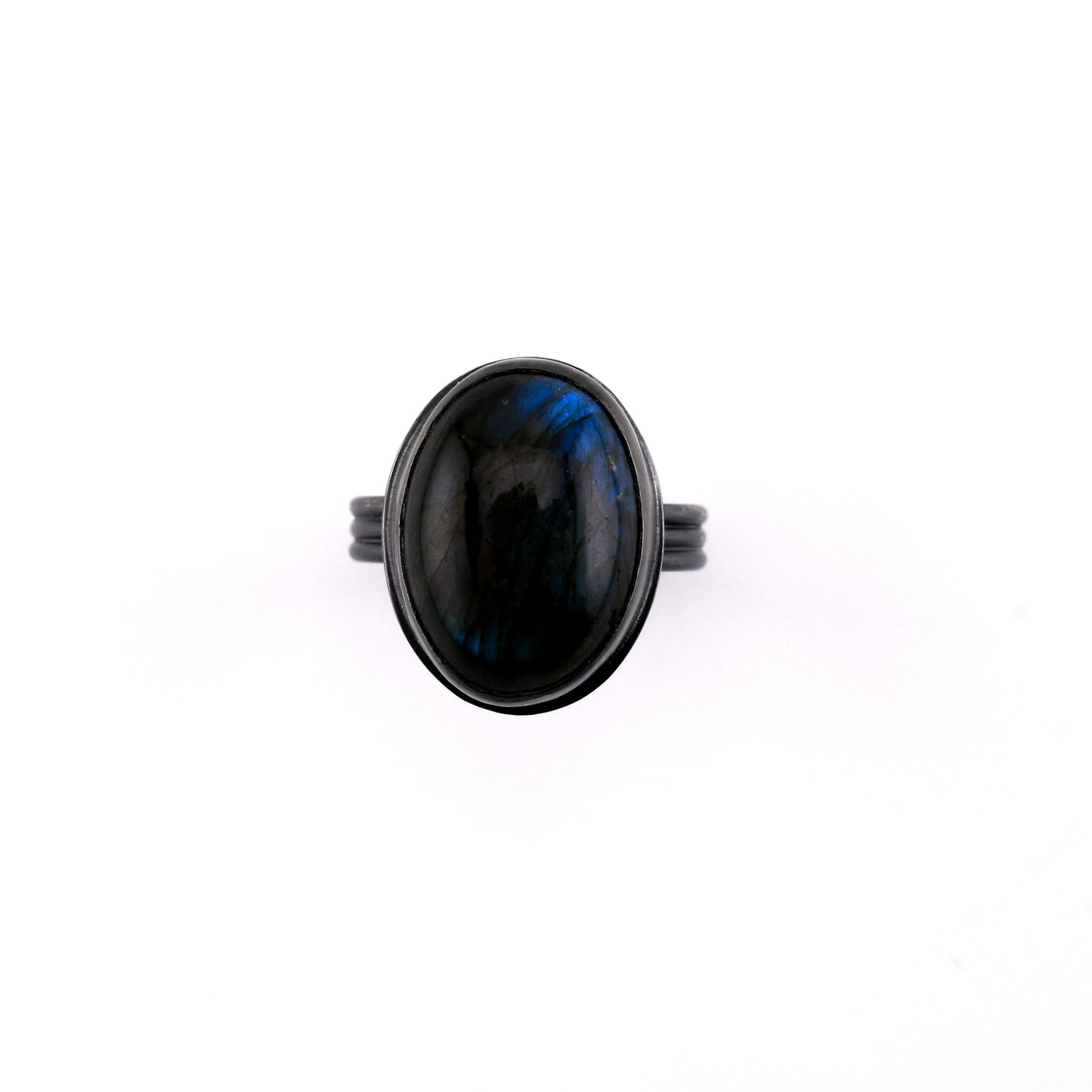 Ring with a black stone on a white background